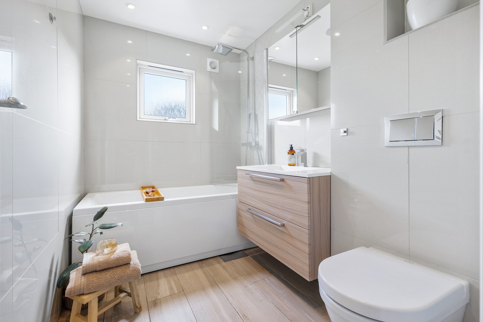 Delikat flislagt bad med varmekabler i gulv, pusset opp i 2017 i regi av tidligere eier som egeninnsats. Innredningen består av stilrent baderomsmøblement, speilskap og vegghengt toalett. Galleribilde