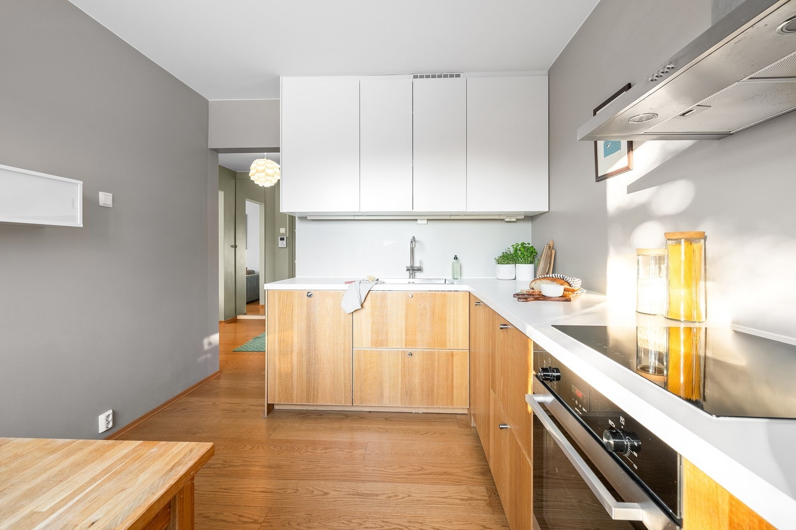 Dette er et moderne kjøkken med god lagrings- og benkeplass. Det er opplegg for vaskemaskin til venstre for kjøkkenvasken. Galleribilde