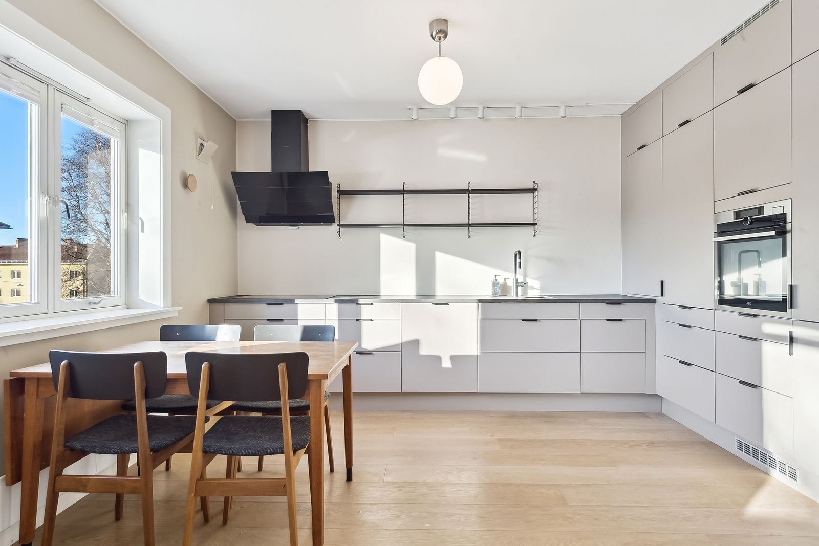 Moderne kjøkken med integrerte hvitevarer, spisebord kan medfølge etter ønske. Galleribilde