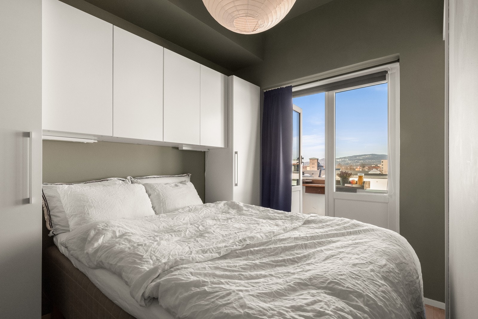 Lunt soverom malt i delikate farger og som vender ut mot rolig gårdsrom. Galleribilde