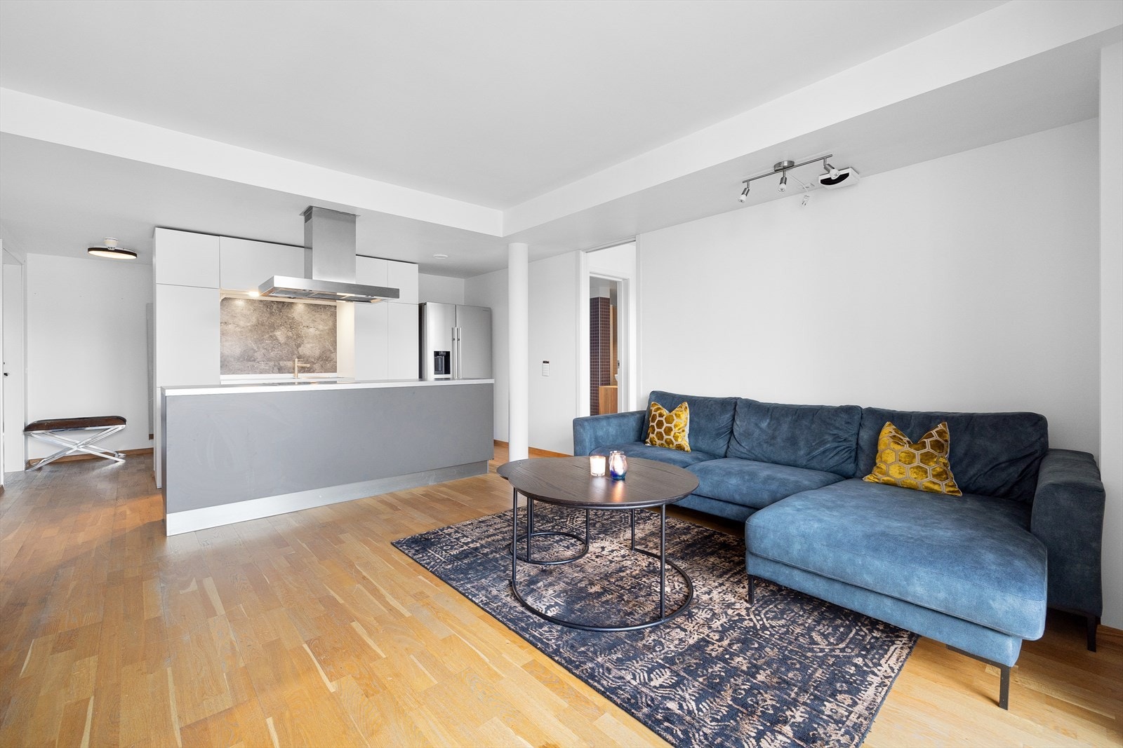 Stor og lys åpen stue-/kjøkkenløsning med plass til sofagruppe og spisebord. Galleribilde