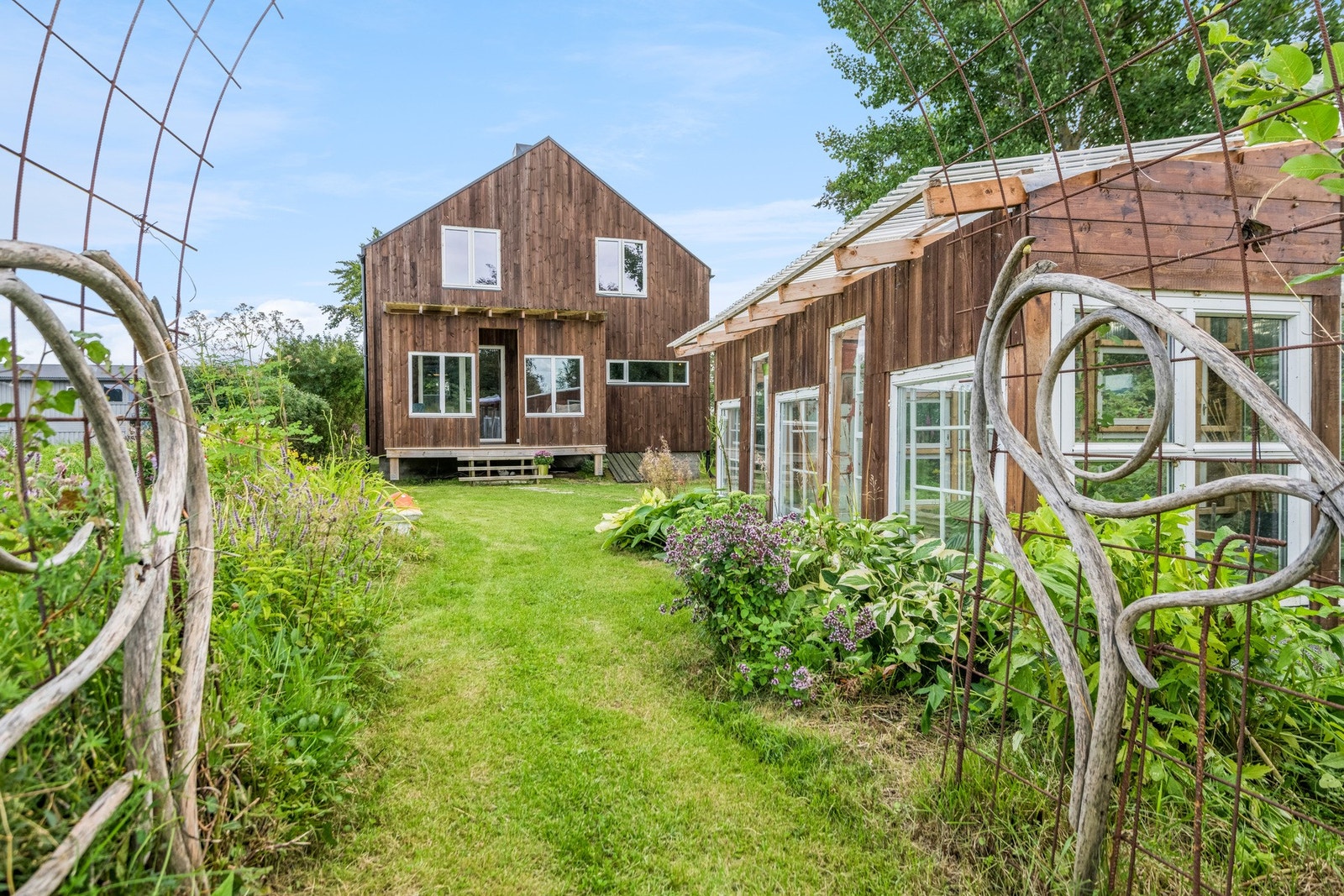 Hagen bugner av busker og bed. Galleribilde