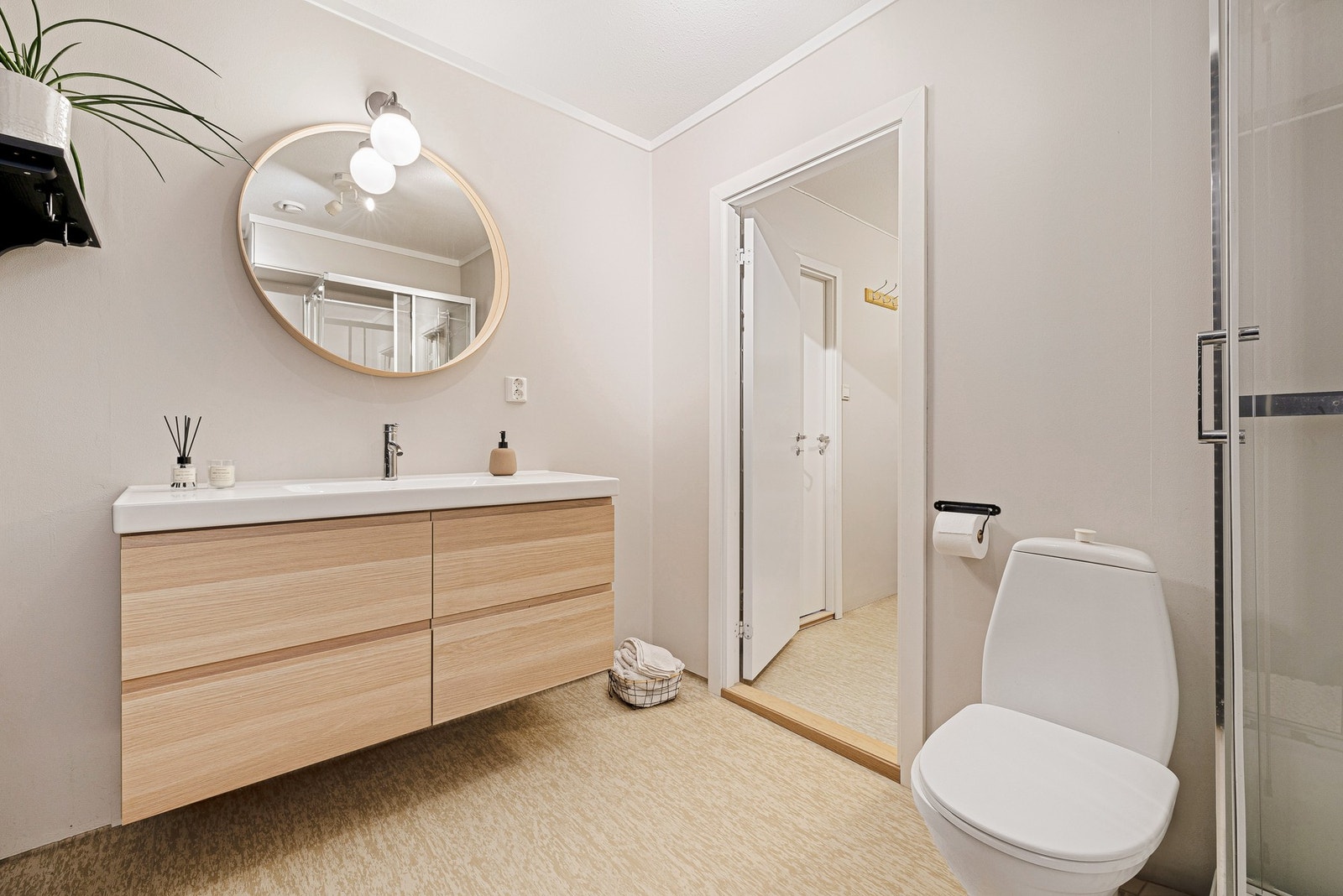 Badet er innredet med servant, belysning, toalett og dusjkabinett Galleribilde