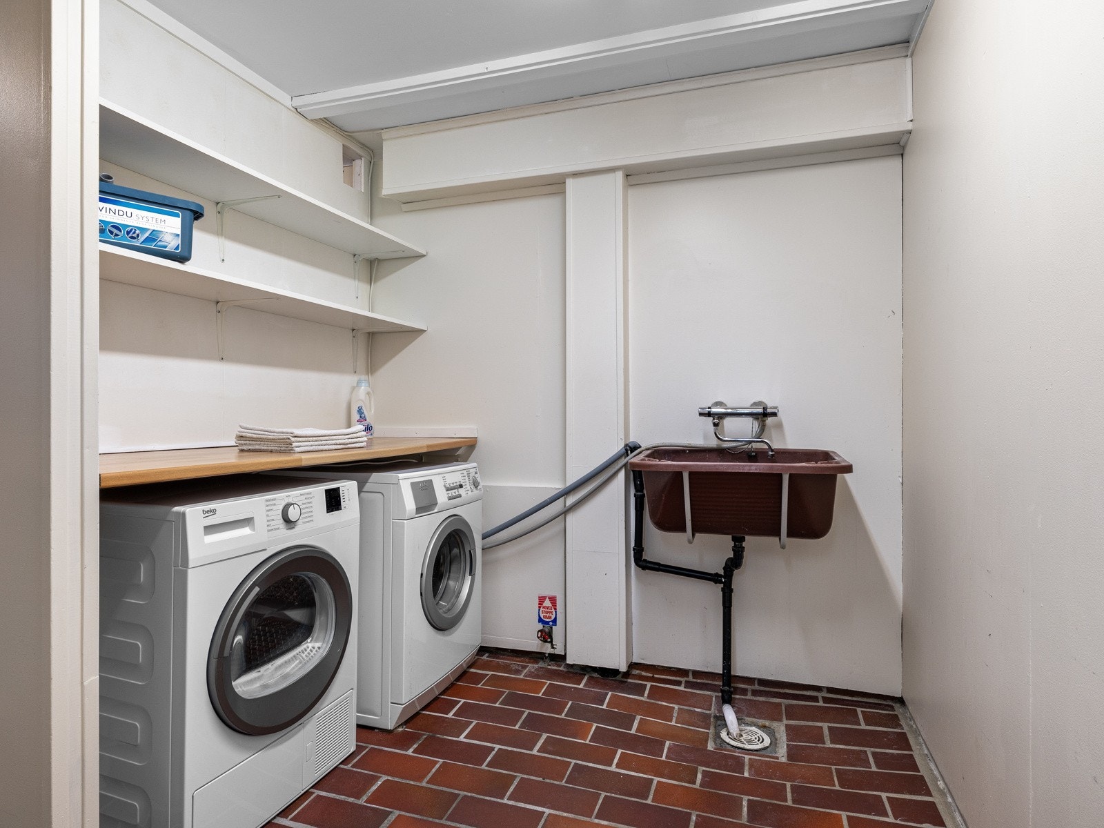 Vaskerom med benkeplate, hyller og utslagsvask Galleribilde