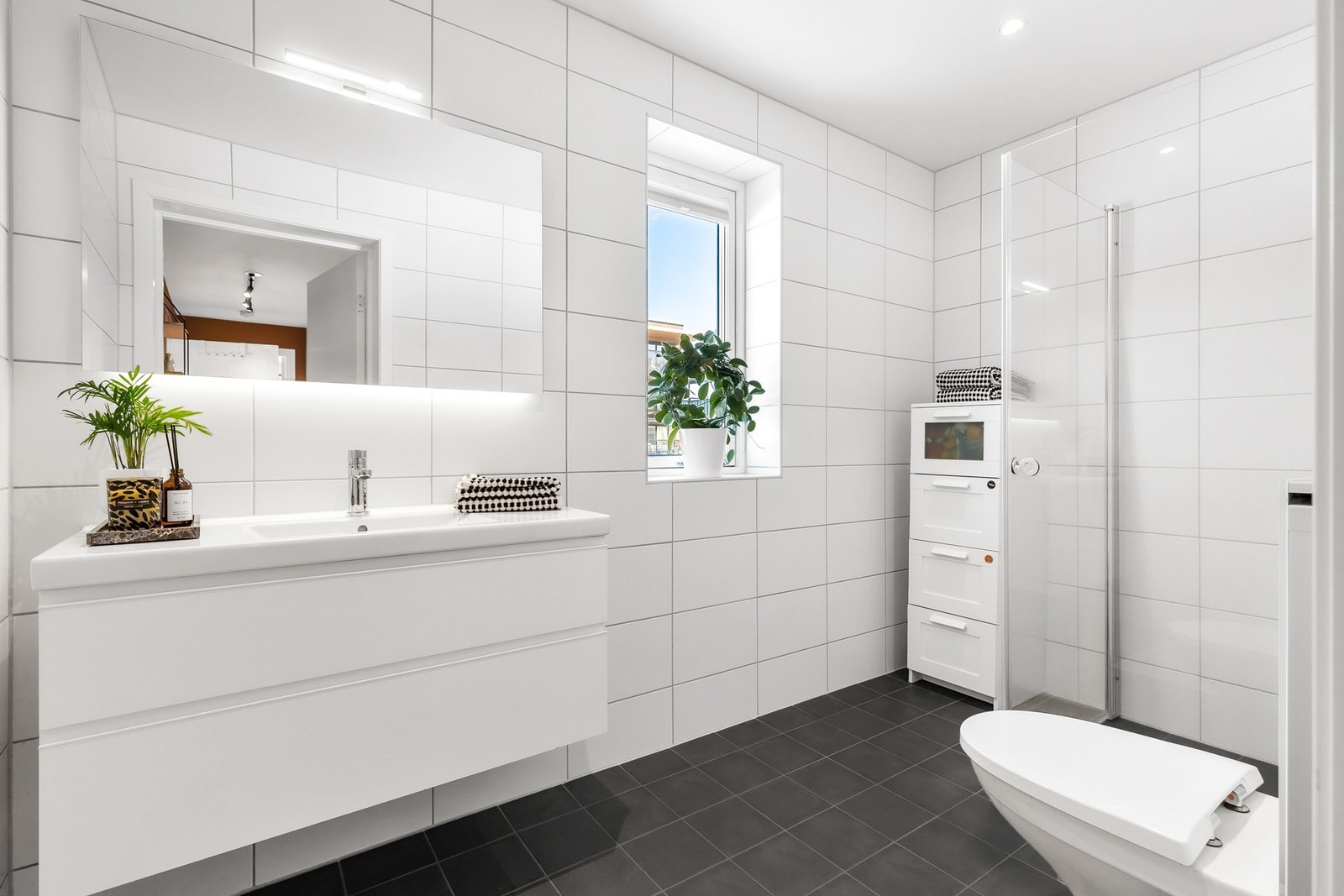 Delikat, helfliset bad med gulvvarme og nedsenket himling med downlights Galleribilde