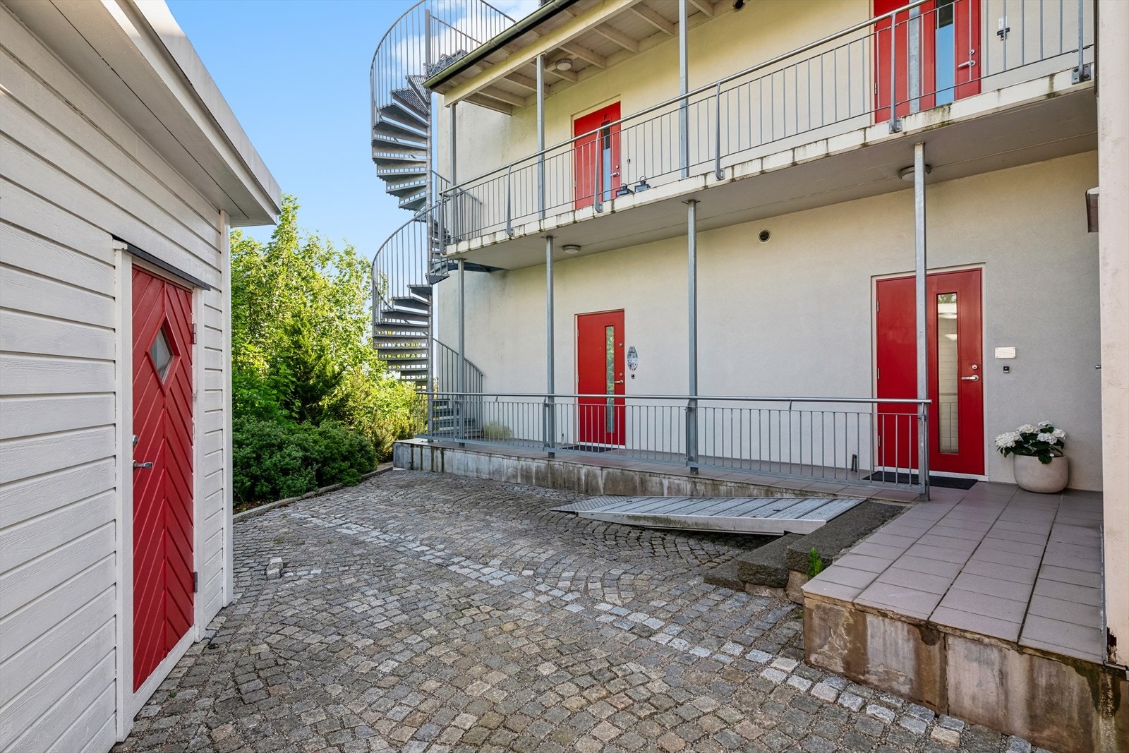 Inngang til leiligheten på hjørnet, tilhørende bod i forkant av bildet Galleribilde