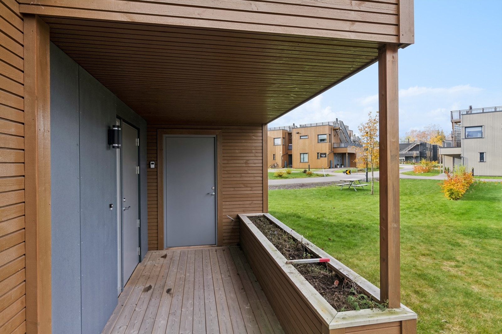 Ved inngangen finnes et innebygd blomsterbed med mulighet for beplantning, samt en bod for oppbevaring av sykler og annet nødvendig utstyr. Galleribilde