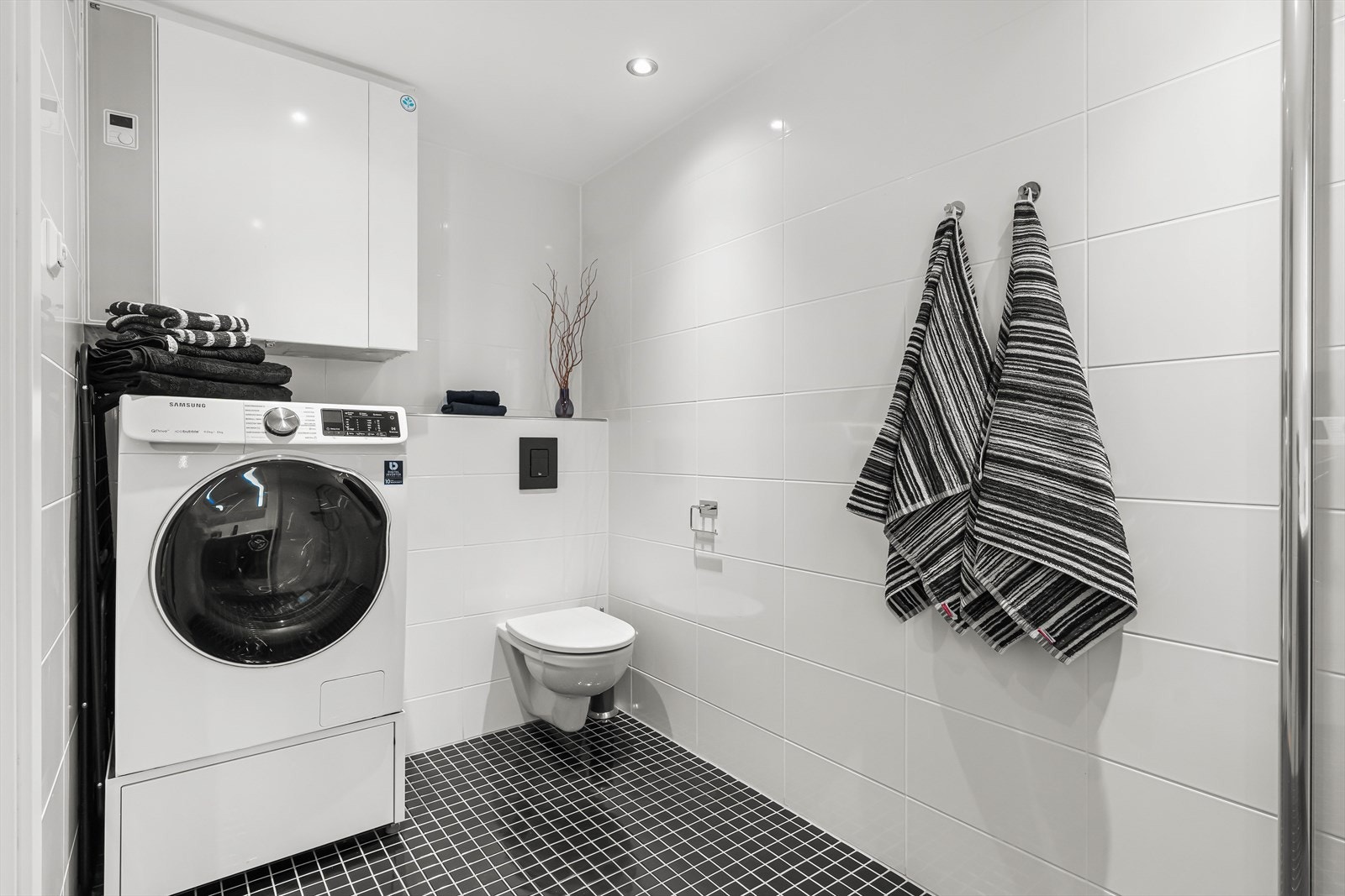 Dette badet har opplegg for vaskemaskin, vegghengt toalett og dusjhjørnet med regnfallsdusj. Galleribilde