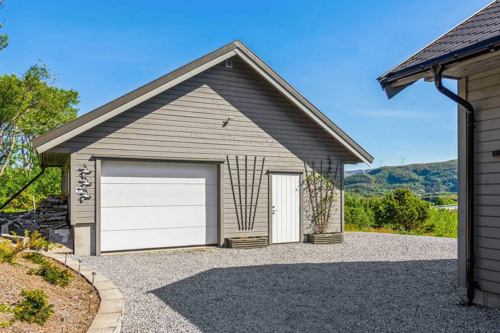 Garasjen har sidedør og mye lagringsplass. Galleribilde