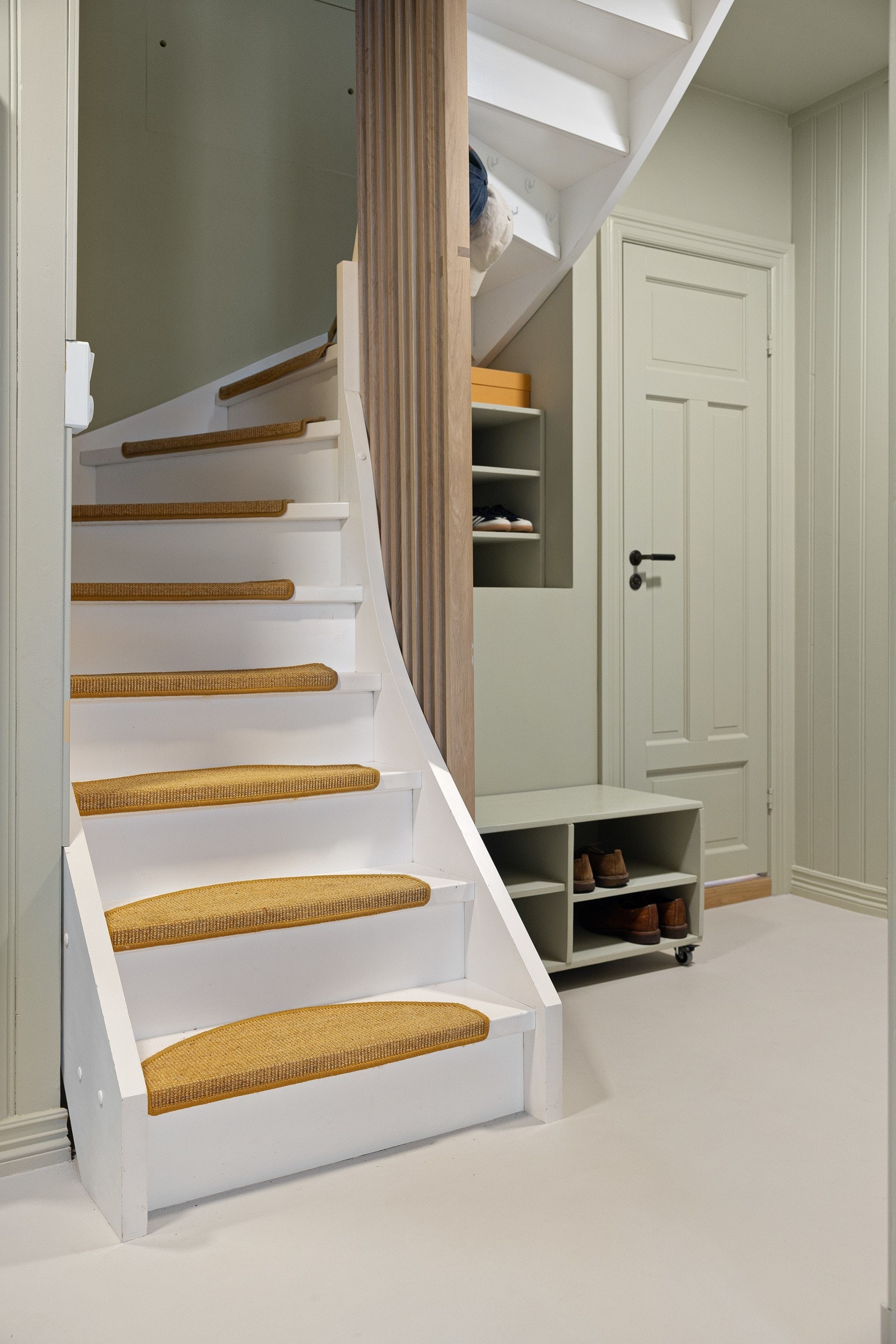 Fra entréen har du en innbydende trapp med møbelsnekret rekkverk i heltre som fører deg opp til leilighetens 2. etasje. Galleribilde