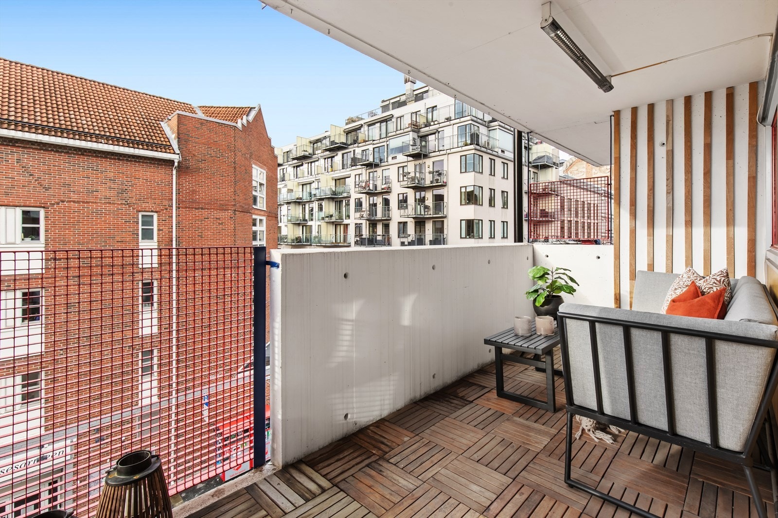 Oveflater fremstår med trebrikker belagt på støpt betongdekke samt rekkverk med spiler i stål. Galleribilde