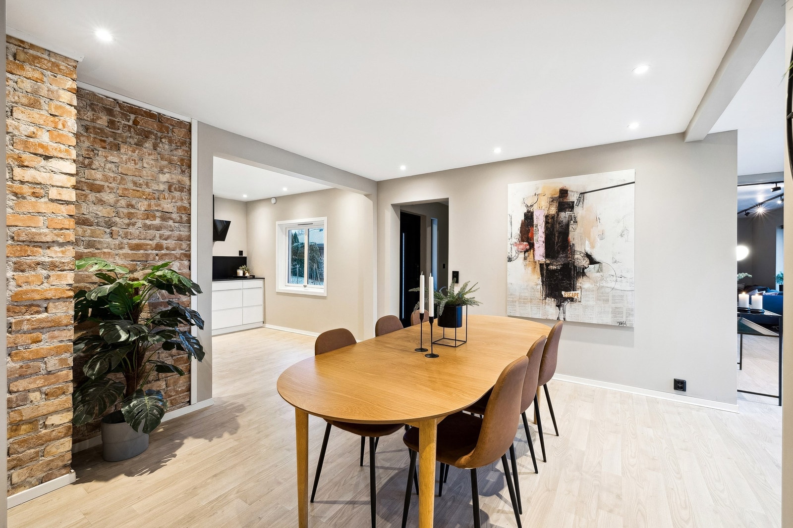 Kjøkkenet med åpen planløsning mot spisestue og stue. Lys og innbydende atmosfære, perfekt for både hverdag og selskap. Galleribilde