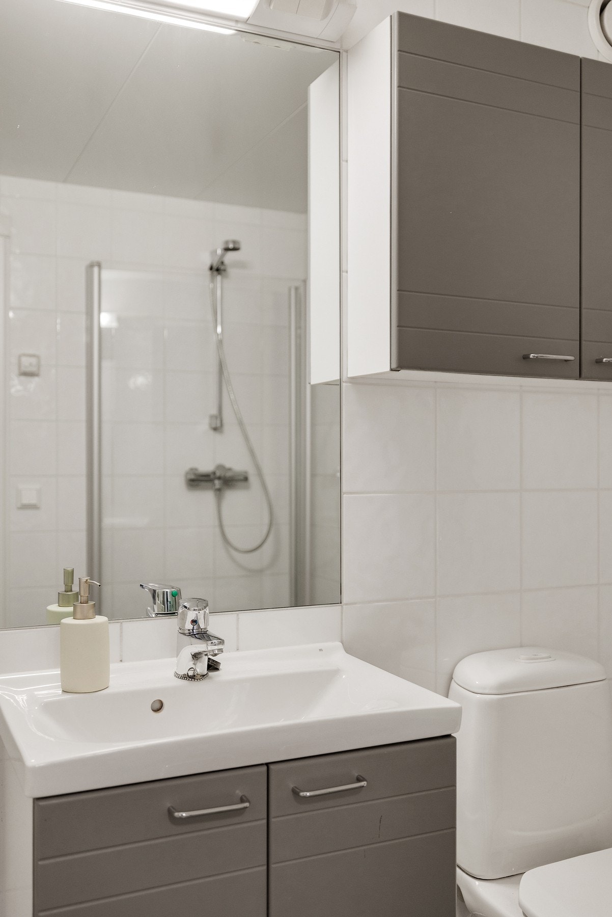 Pen badersomsrinnredning med god plass til oppbevaring av personlige artikler Galleribilde