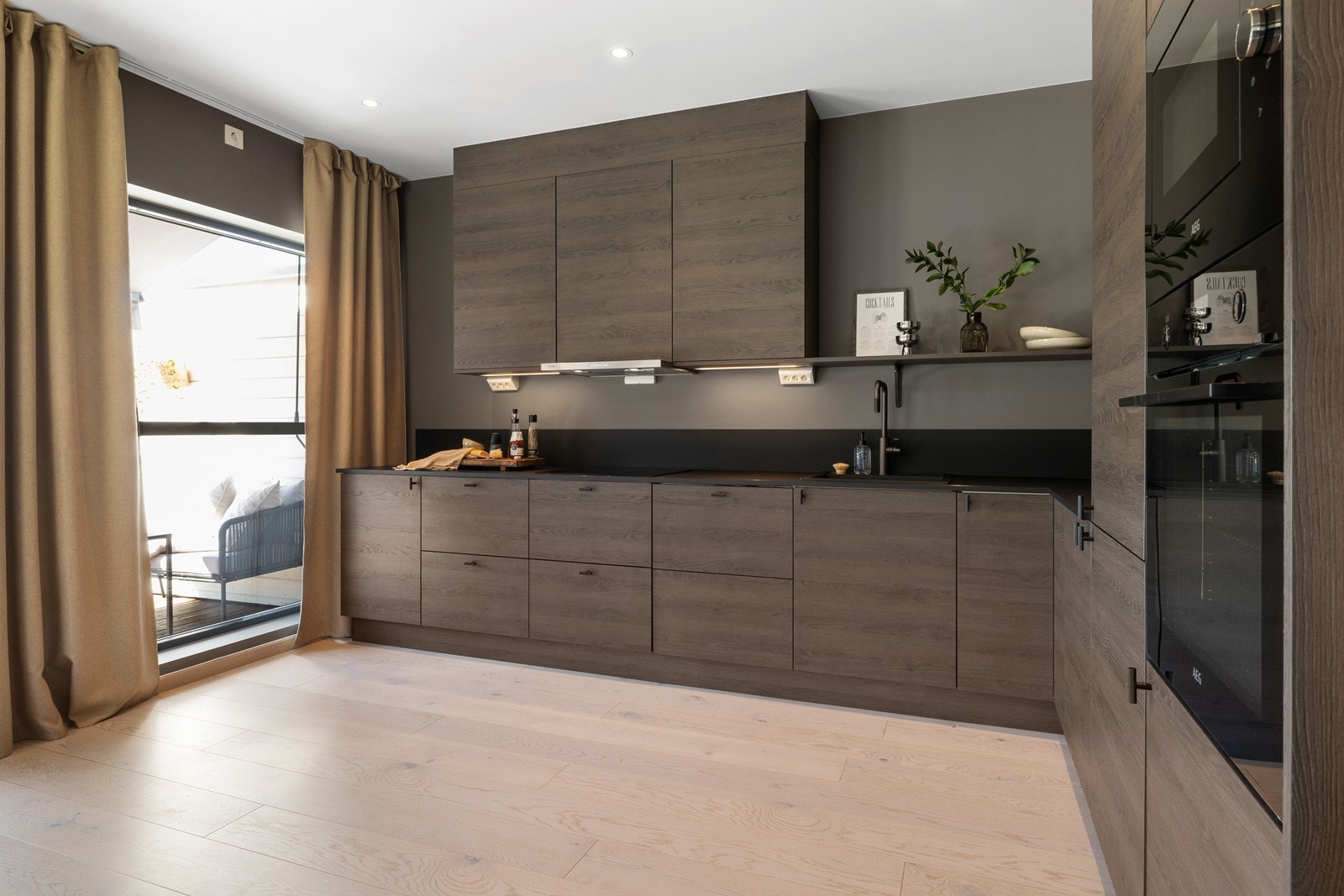 På begge sider av komfyren er det monter arbeidslys og strømuttakt under overskapene. Galleribilde