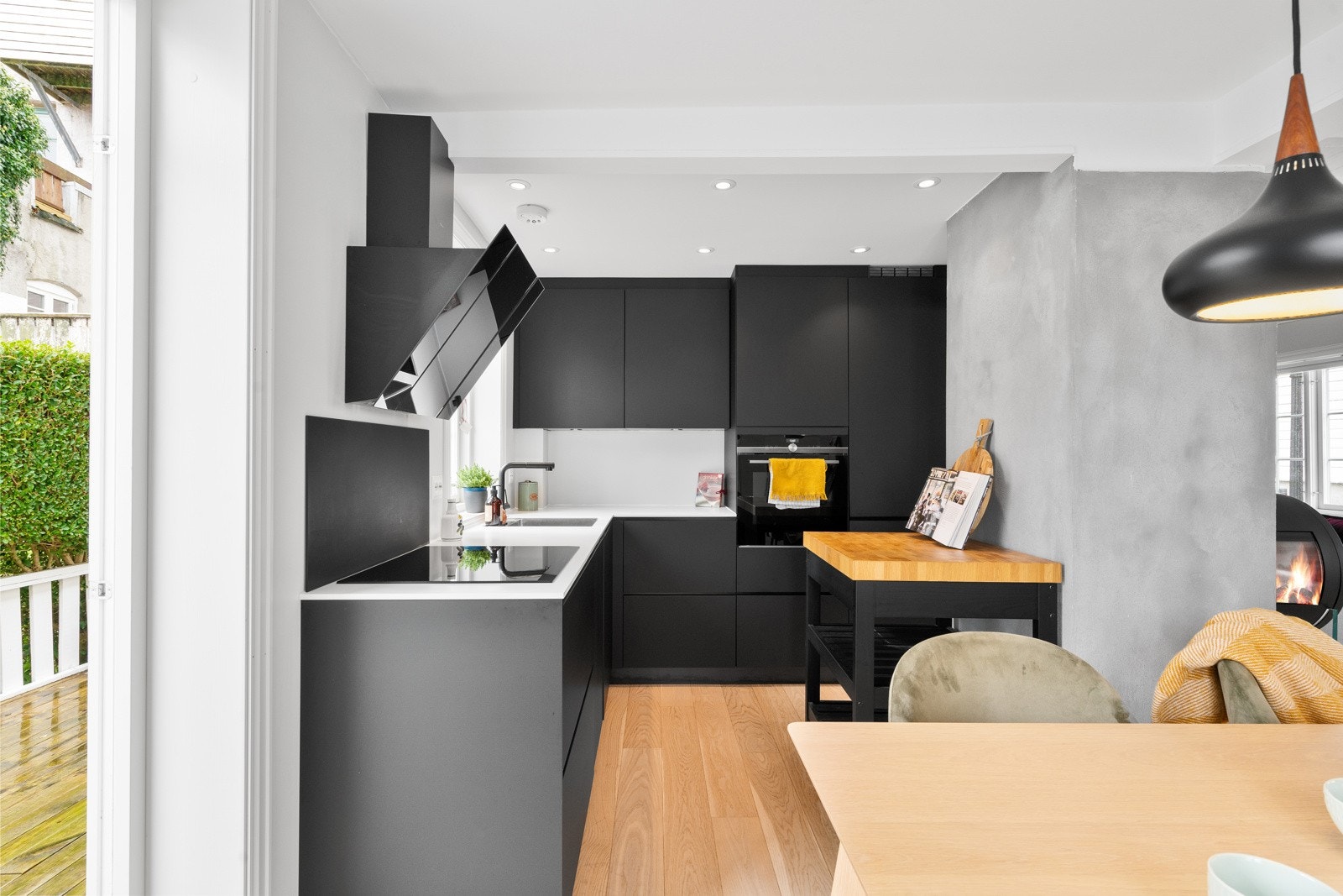 Kjøkkenet har sorte fronter, hvit benkeplate og hvitevarer fra Siemens. Galleribilde