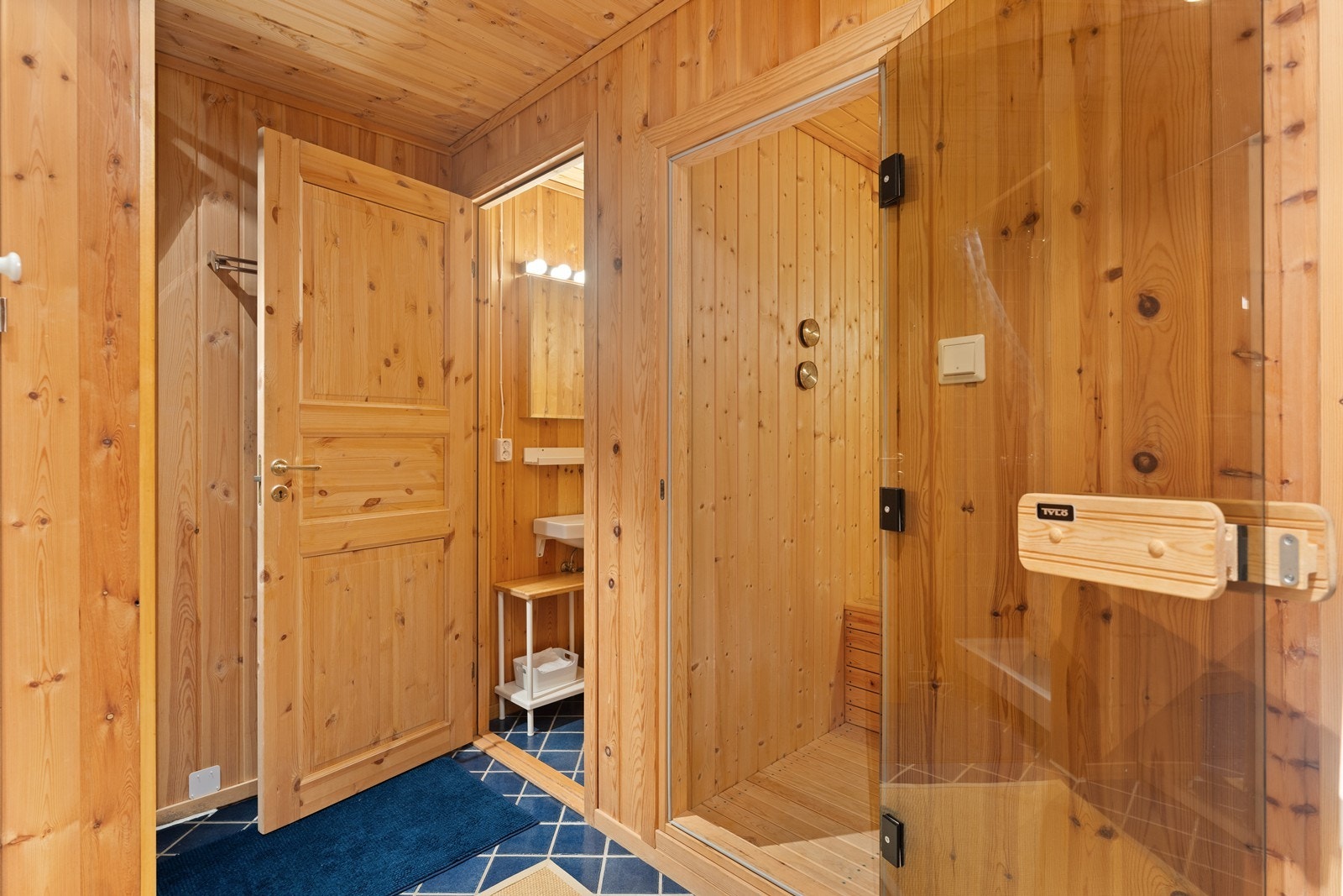 I tilknytning til kjellerstuen et omkledningsrom med dusjnisje, en badstue og et toalettrom Galleribilde