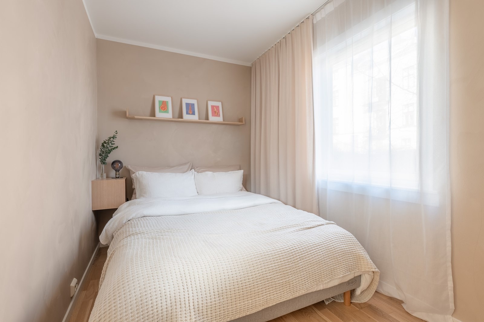 Lunt, delikat og behagelig soverom med plass til dobbeltseng, nattbord og garderobeskap Galleribilde