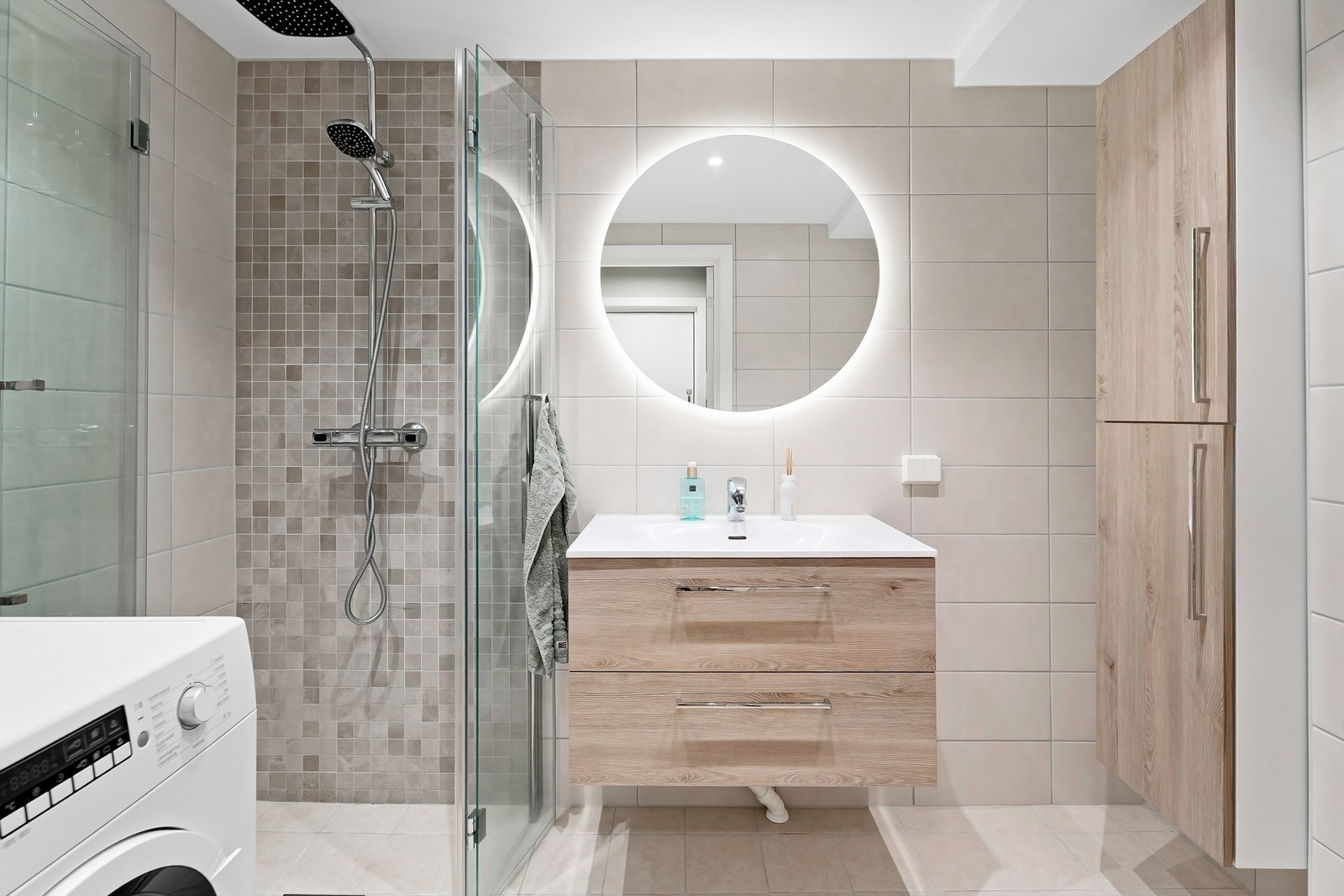 Baderom rehabilitert i 2020 i regi av borettslaget. Her er det opplegg for vaskemaskin, flislagte gulv med gulvvarme, flislagte vegger og nedsenket himling med downlights. Galleribilde