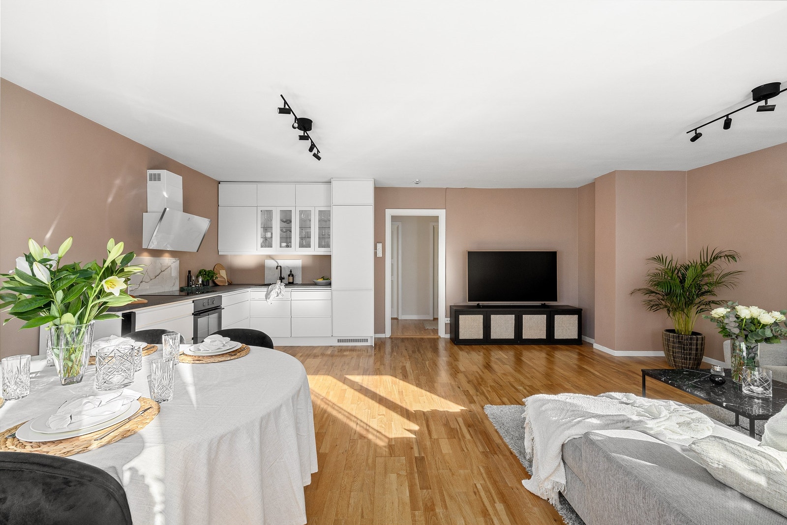 Stuen og kjøkkenet er holdt i en åpen løsning, noe som gjør at rommet blir et naturlig og sosialt samlingspunkt i boligen. Galleribilde