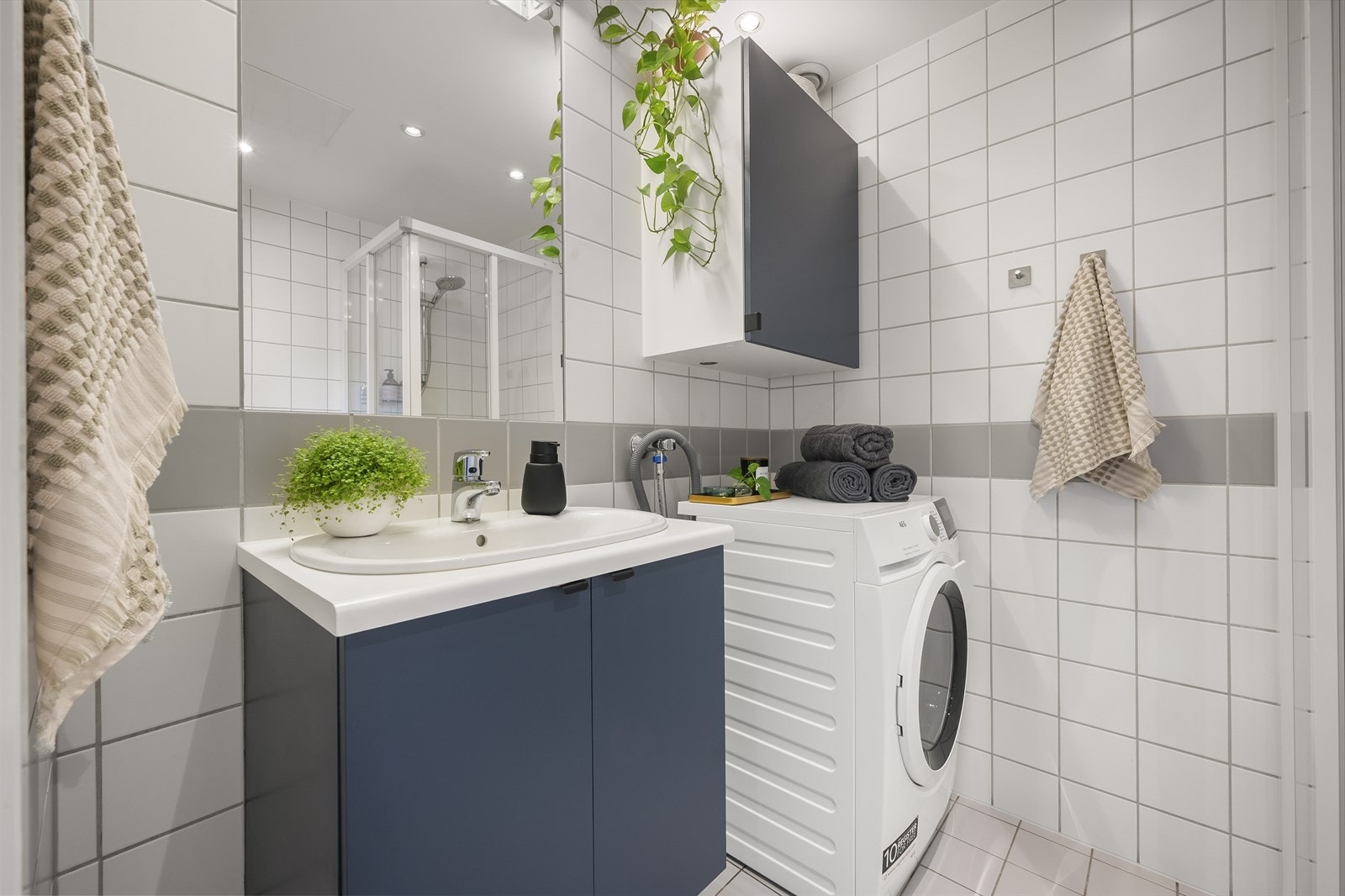 Badet har nøytrale og tidløse fliser, behagelig gulvvarme og downlights i taket Galleribilde