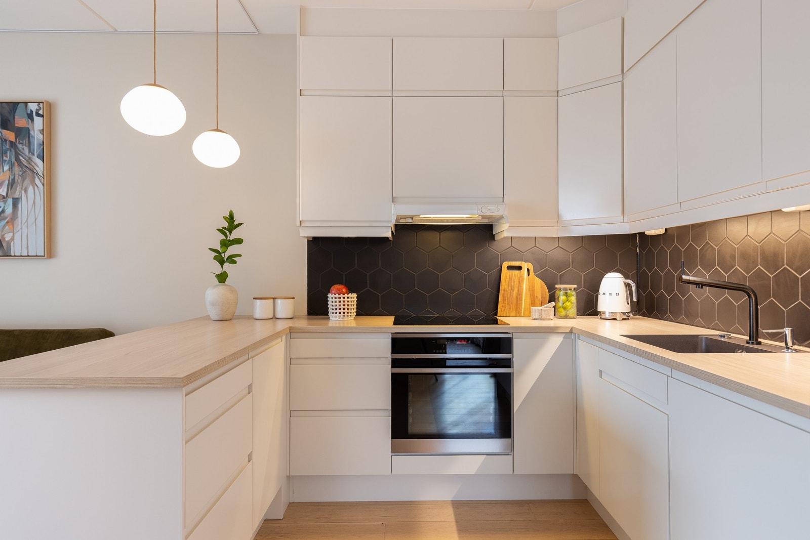 Her er det rikelig med lagringsplass i skap og boltreplass ved kjøkkenbenken. Galleribilde