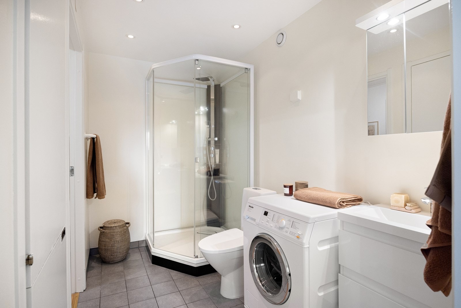 Badet har varmekabler i gulvet, frittstående toalett og dusjkabinett. Det er opplegg for vaskemaskin, servant med underskap og speilskap. I tillegg er det downlights i himlingen og mekanisk avtrekk via felles avtrekkskanal. Galleribilde