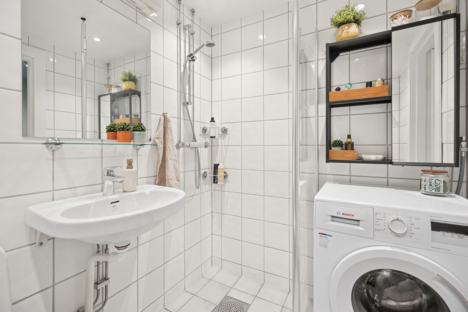 Badet er innredet med Servant, wc, dusj hjørne med glassvegg og oppsett for vaskemaskin. Galleribilde