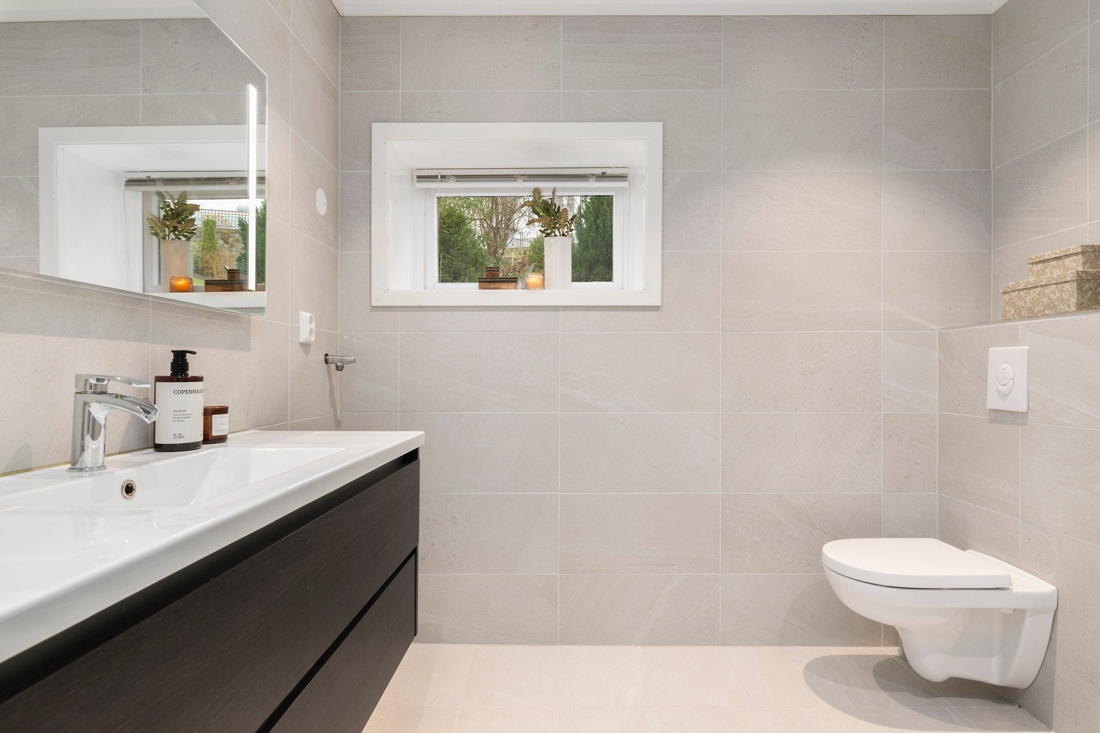 Badet er strøkent og har fliser på gulv og vegger, og selvsagt varmekabler i gulvet. Galleribilde