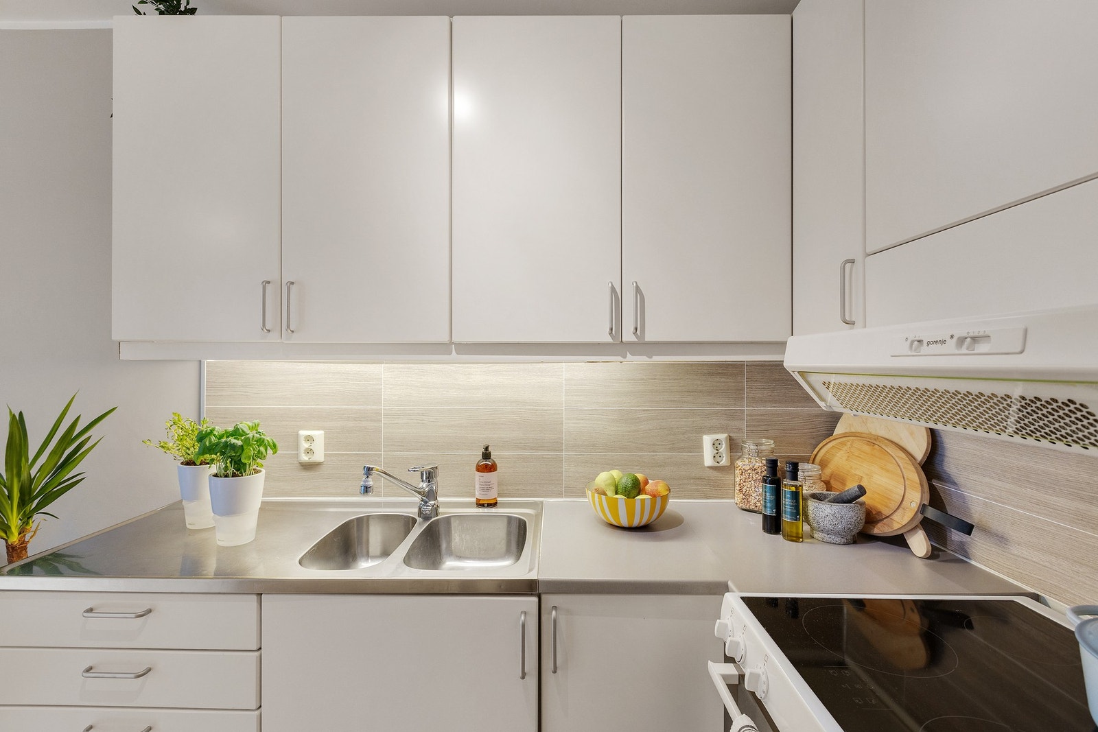 Innredning med glatte fronter, samt benkeplate i laminat og stål. Galleribilde