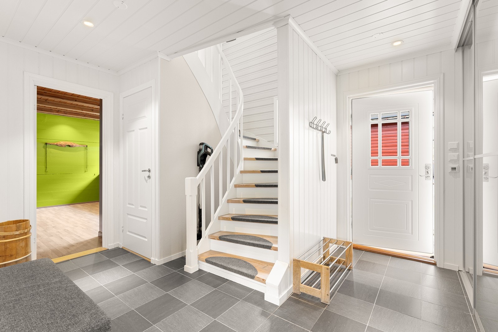 Du har adkomst via et overbygget inngangsparti, hvor du videre ønskes velkommen inn i en trivelig entré med god plass til jakkeoppheng, skohylle og andre oppbevaringsløsninger Galleribilde