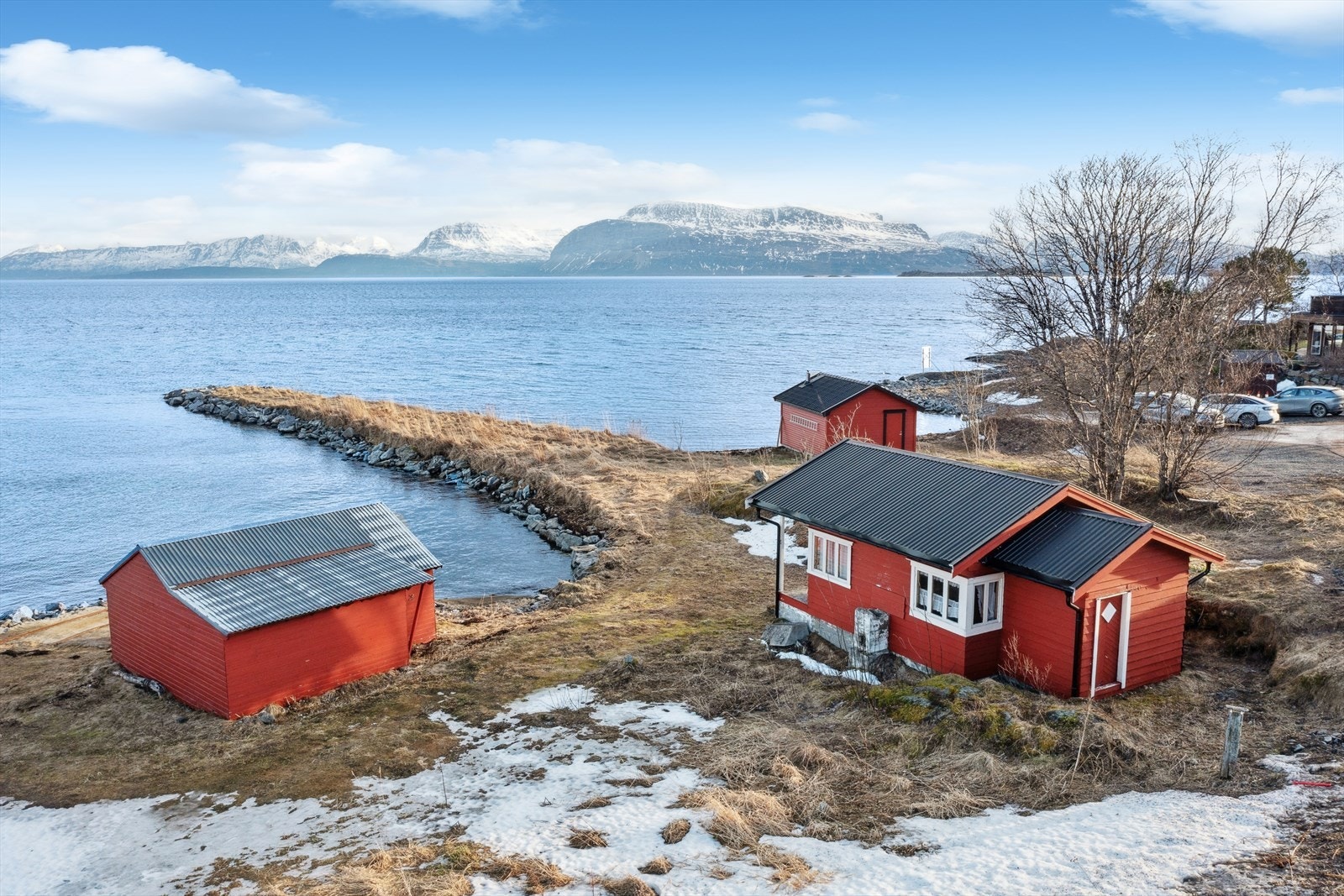 Panoramautsikt mot sjø og vakre fjellformasjoner. Gammel hytte til høyre i bildet følger med på handelen, men forutsettes revet. Galleribilde