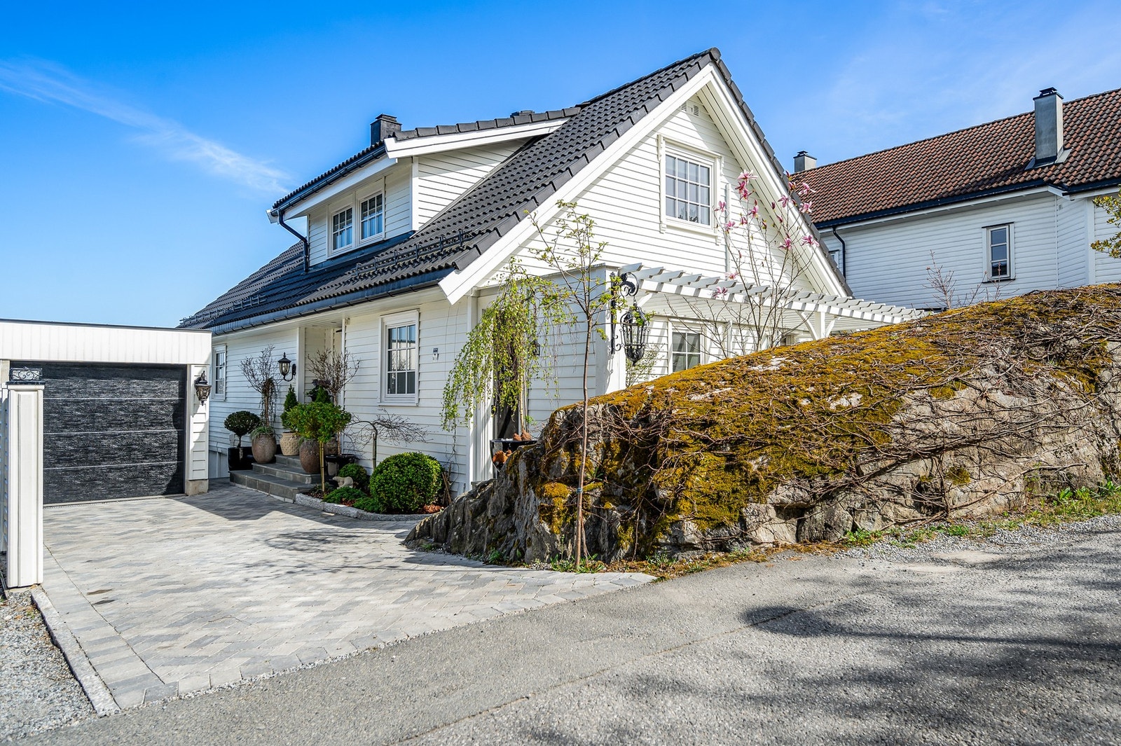 Carport med elektrisk leddport og parkering på gårdsplassen. Galleribilde
