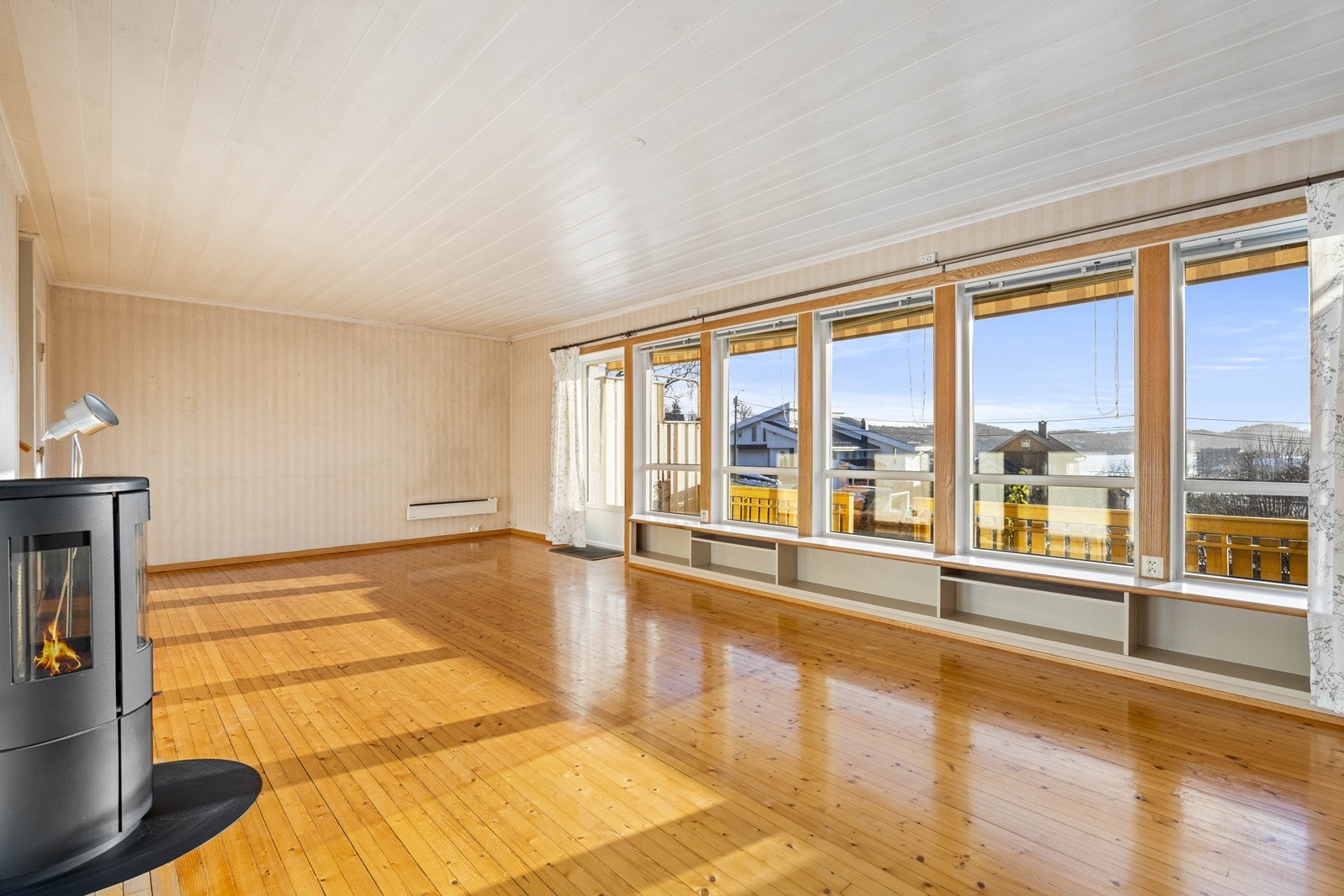 Store vindusflater gir rommet rikelig med naturlig lys Galleribilde