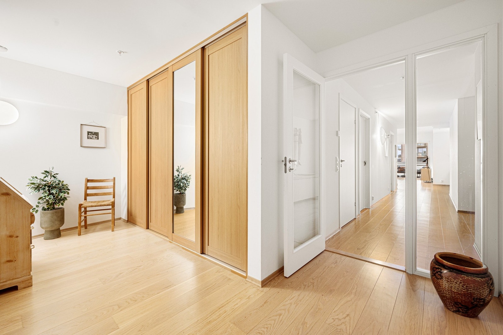 Romslig entrè med skyvedørsgarderobe for sko og yttertøy. Galleribilde