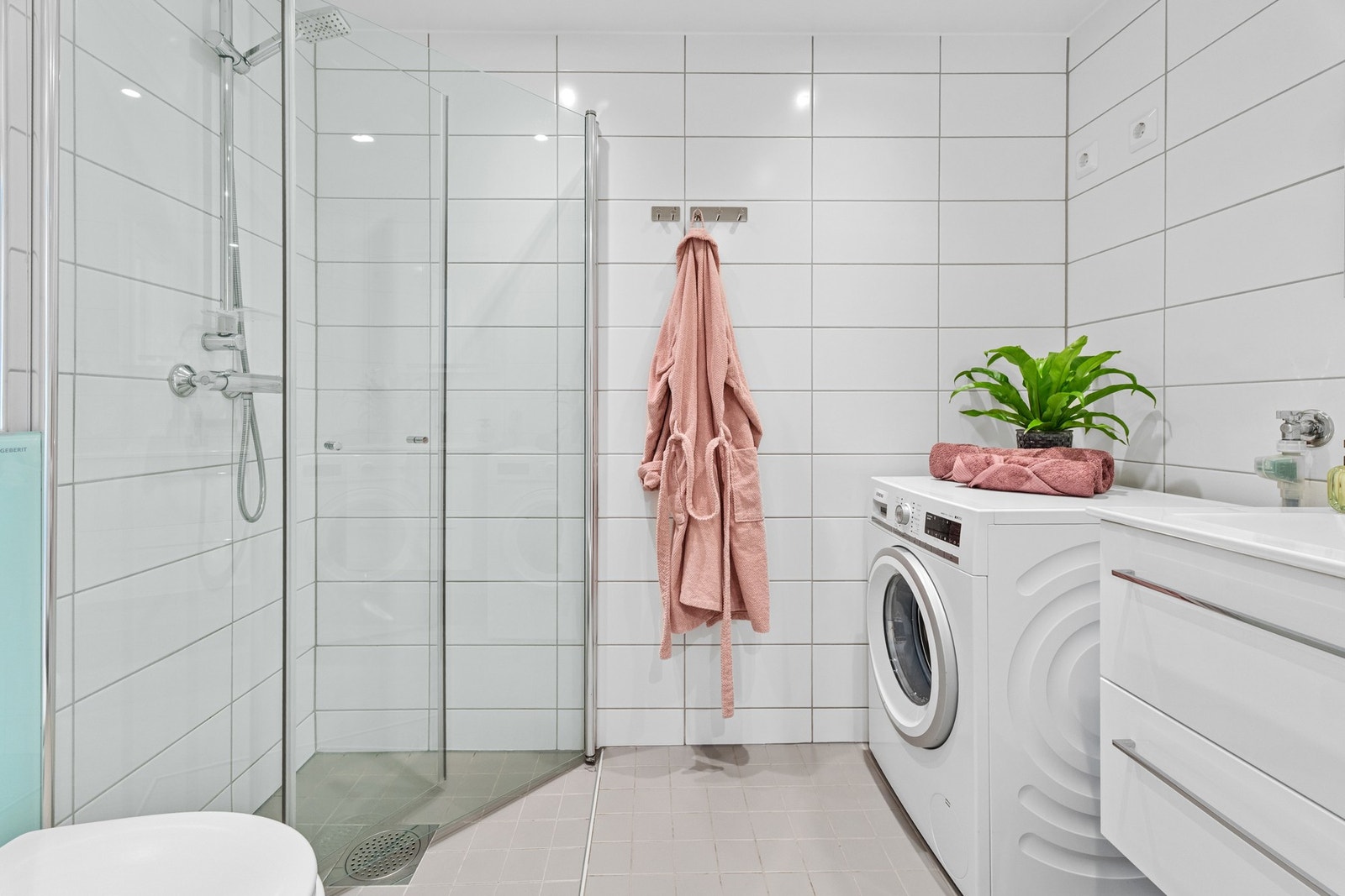 Lekkert baderom fra 2018 med gulvvarme, downlights og opplegg for både vaskemaskin og tørketrommel Galleribilde