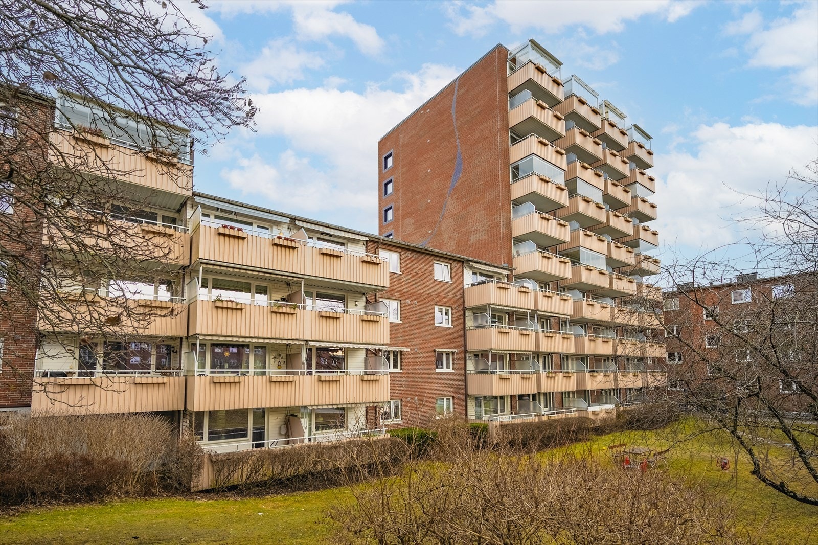 Fellesarealene er pent opparbeidet med stor plen, beplantning, lekeapparater og sittegrupper. Galleribilde