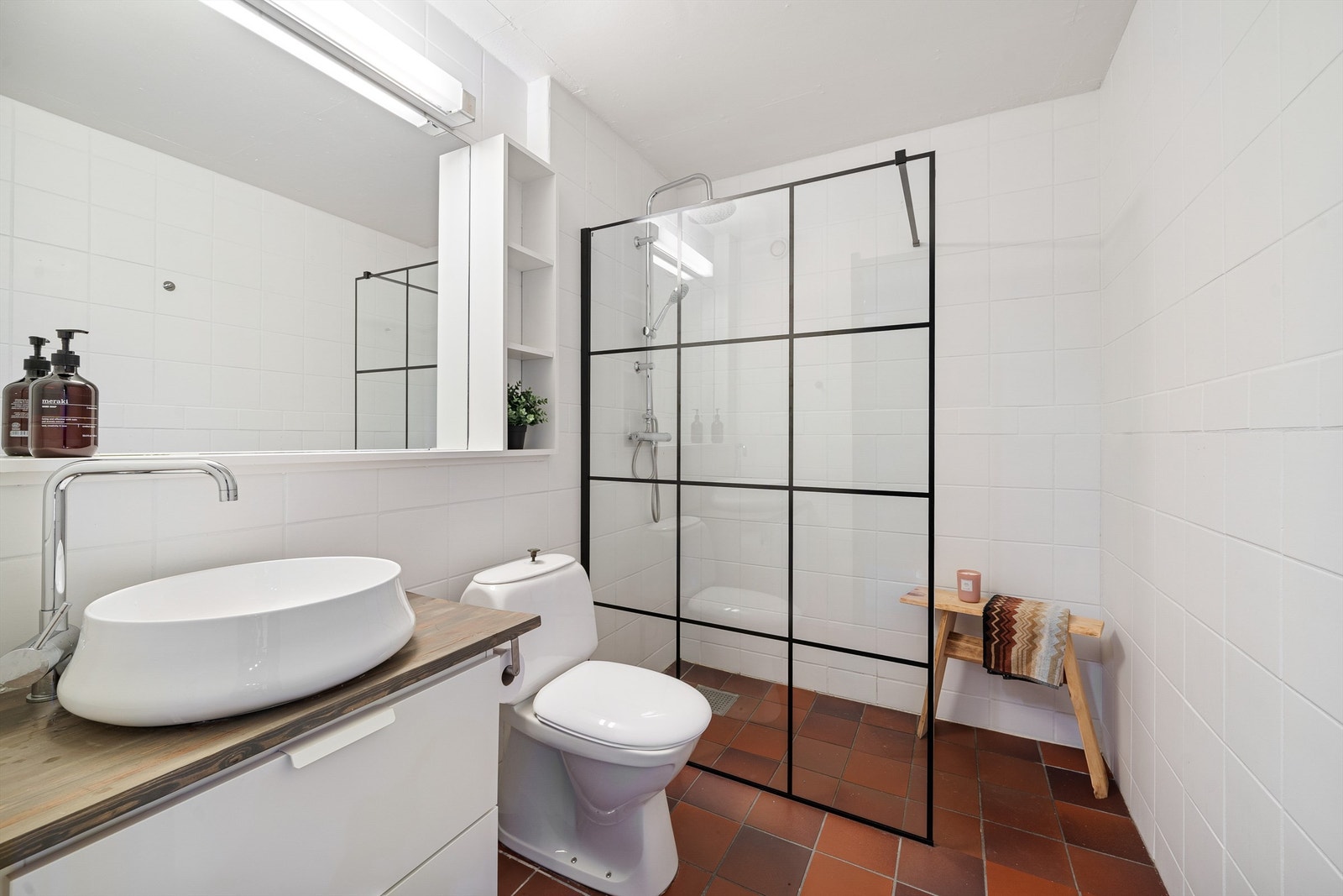 Badet har wc, servant med skuffer under og dusjhjørne. Galleribilde