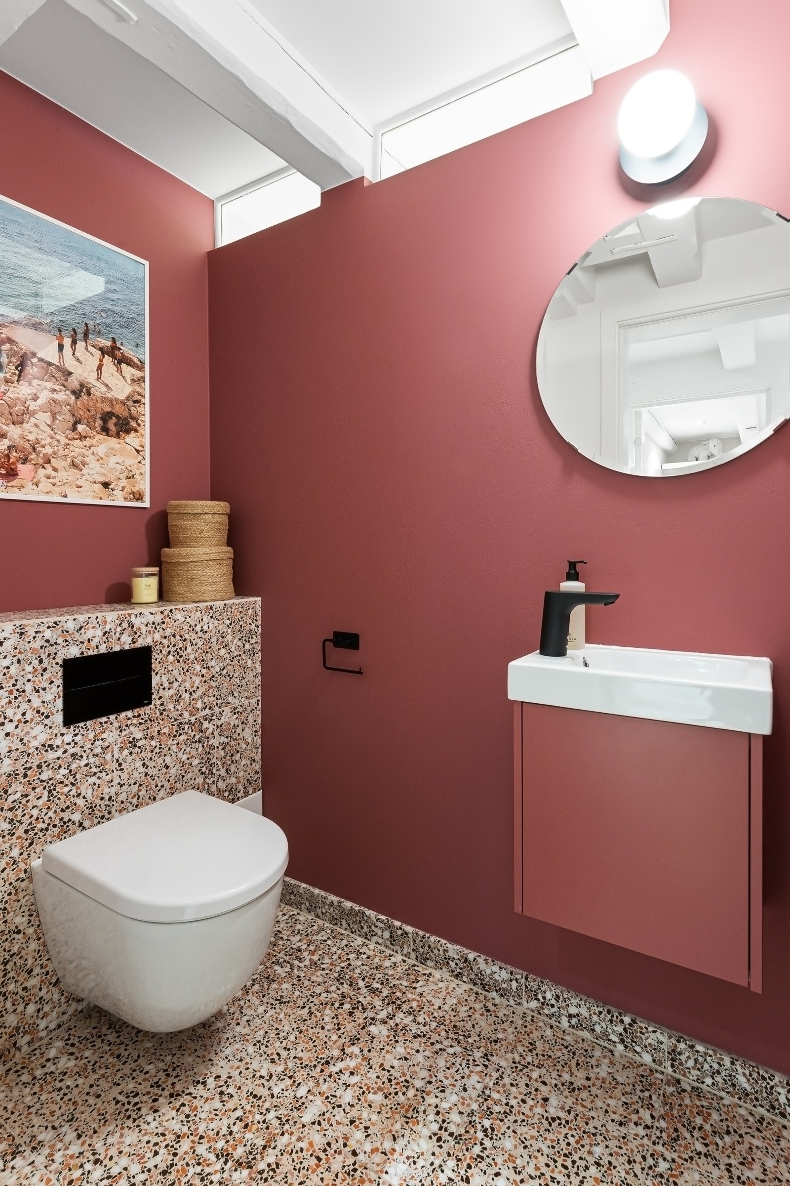 Veggene er malt i en dyp, tidsmessig rødtone, og på gulvet er det lagt stilfulle terrazzofliser. Galleribilde