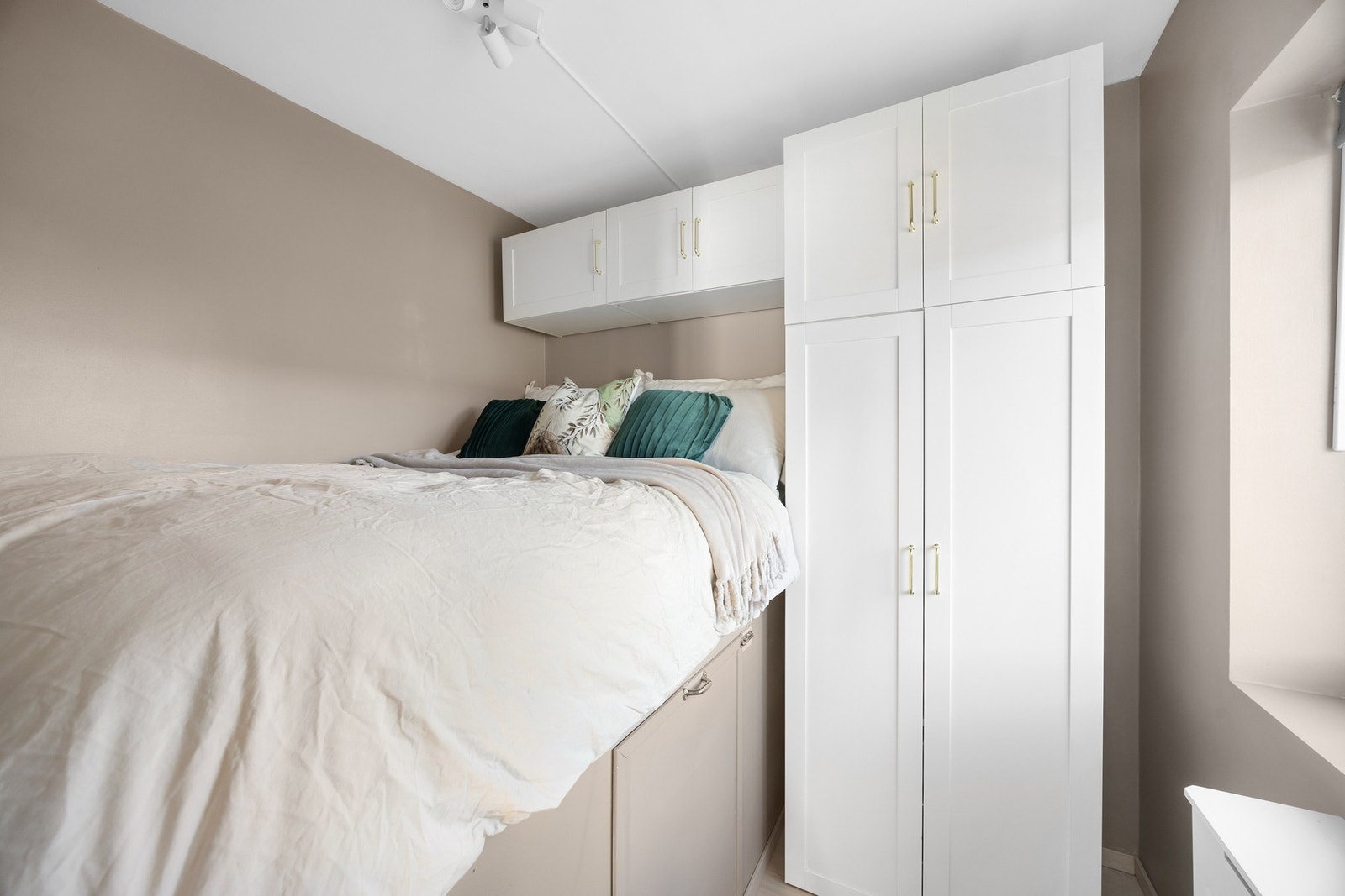 Plassbygd seng med smart garderobeløsning rundt. Galleribilde