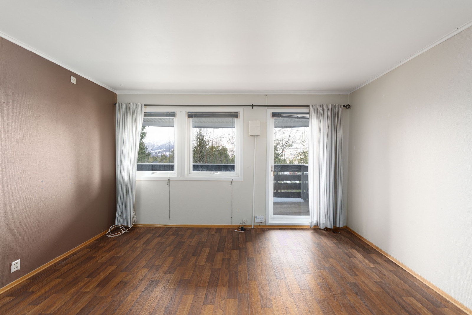 Stuen har store vinduer som slipper inn naturlig lys Galleribilde