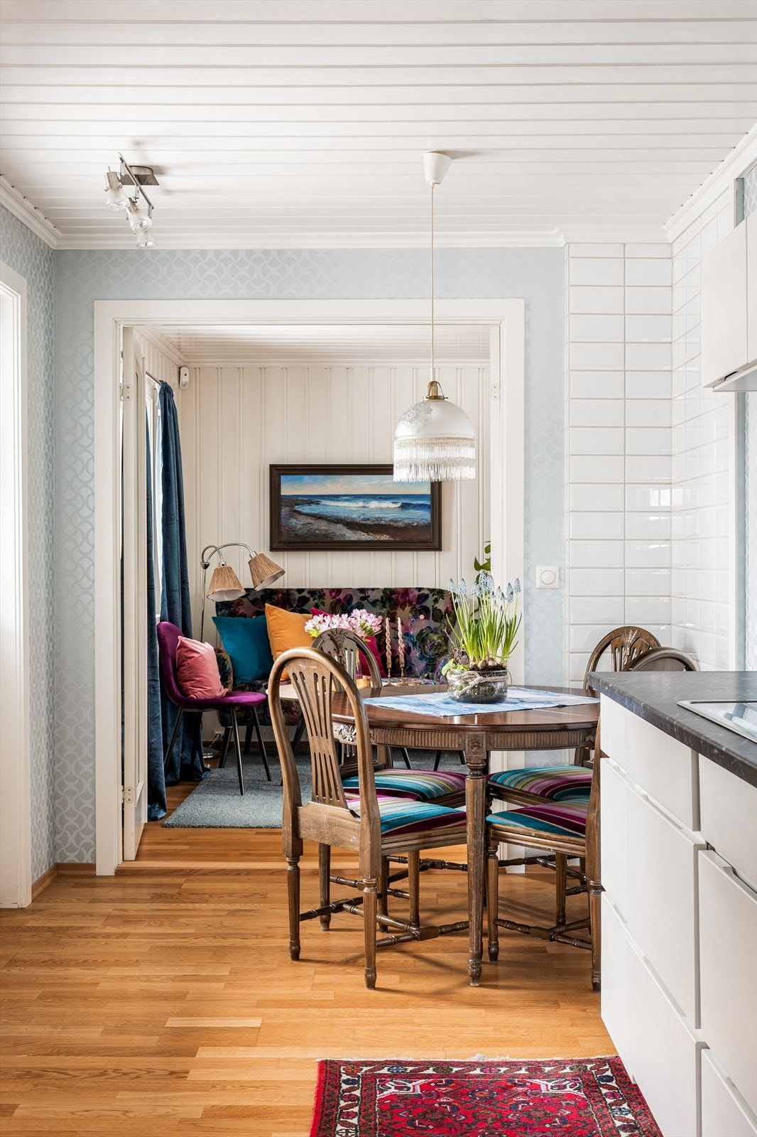 Fra kjøkkenet titter vi inn i stuen som har en liten sofakrok før du går videre til spiseplass og sofa med salongbord. Galleribilde