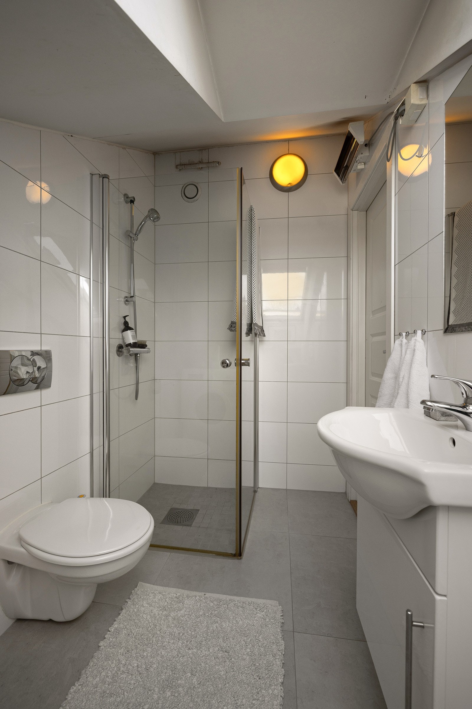 Det er innredet med servant med underskap, toalett og dusjhjørne med glassdører. Galleribilde