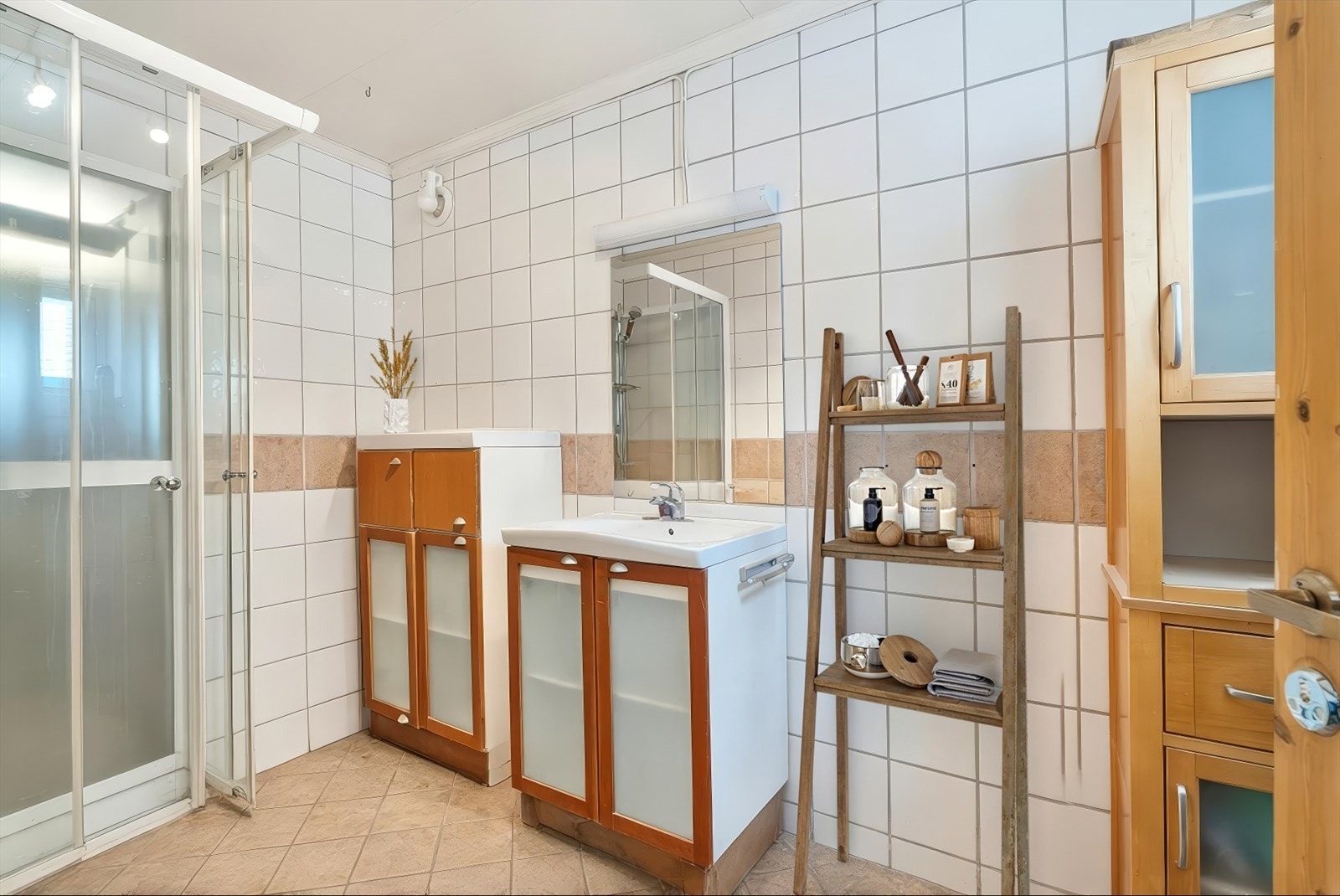 Flislagt bad med varmekabler, innredning med nedfelt servant, toalett og dusjkabinett - Vegg i vegg med badet er det bod med sluk (ukjent om bod har membran) Galleribilde