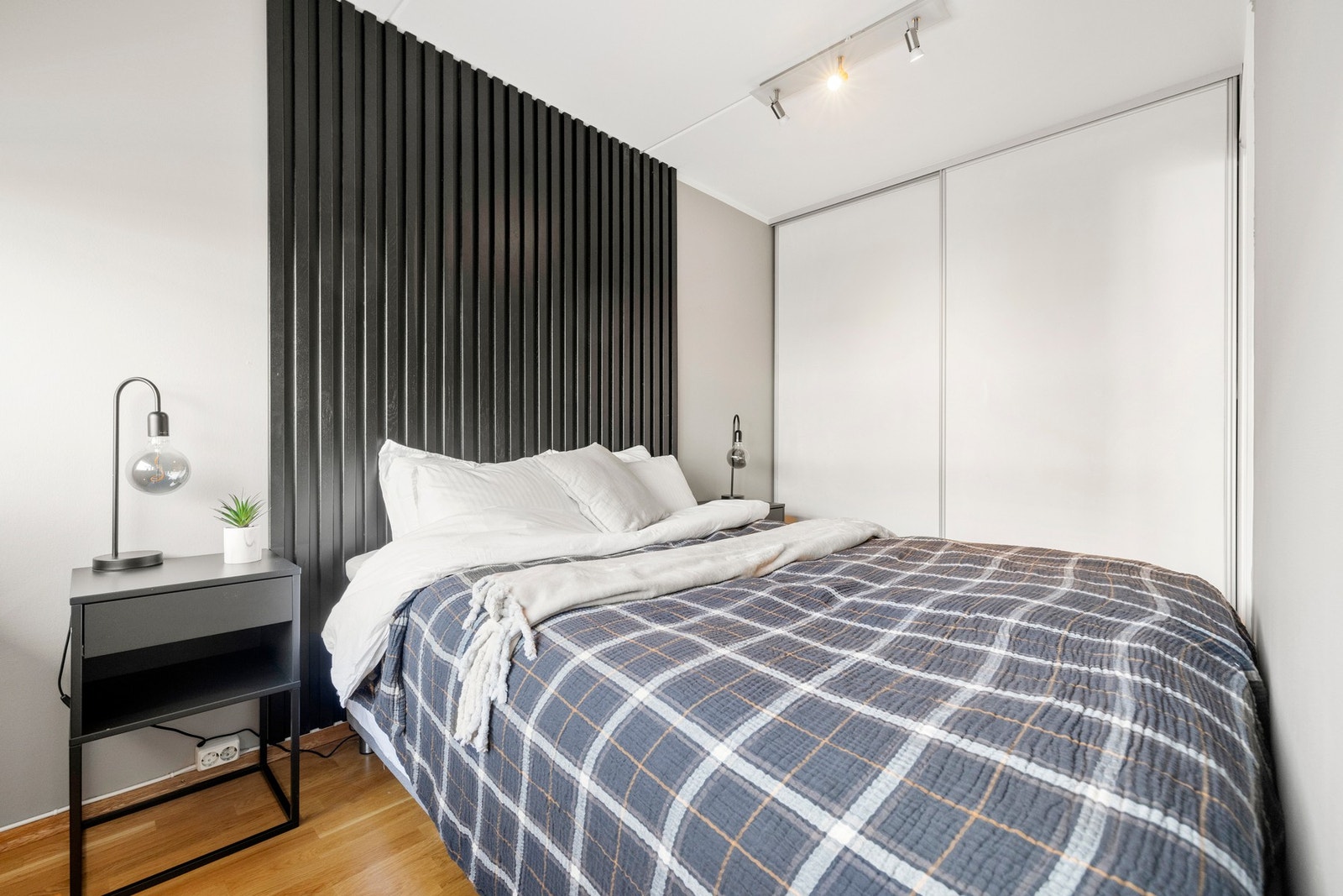 Soverommet har en stilig spilevegg bak sengen og en stor skyvedørsgarderobe. Galleribilde