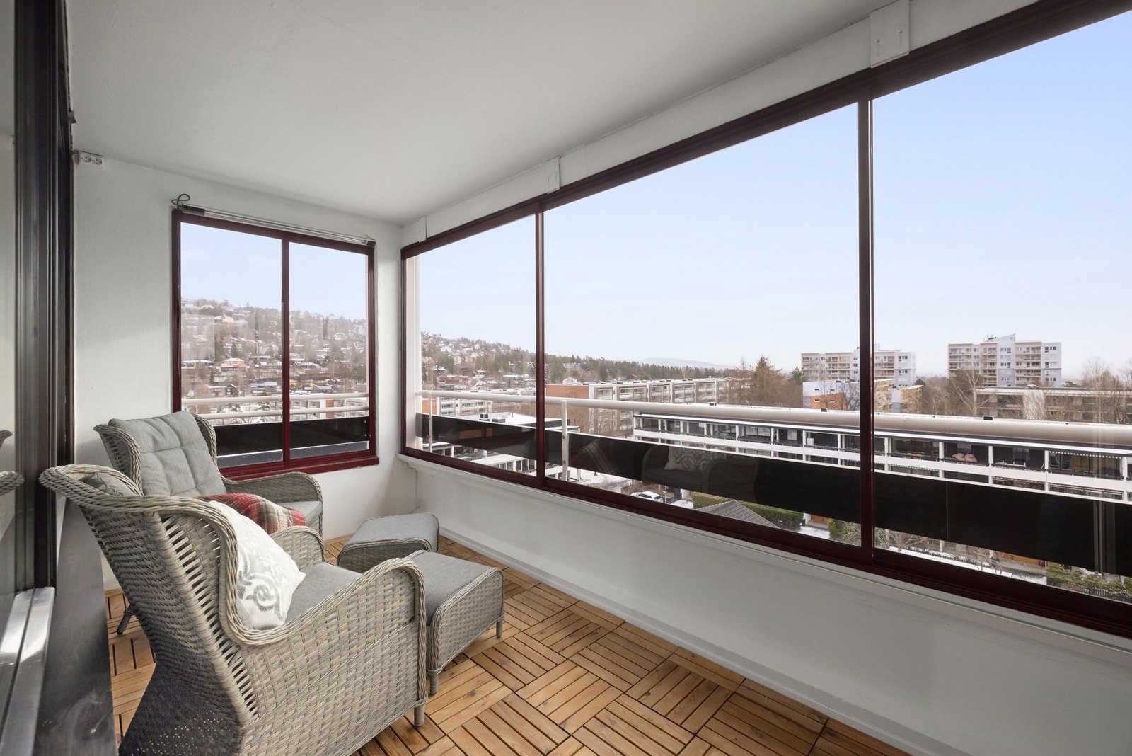 Innbydende balkong med koselig sitteplass og panoramautsikt over det rolige nabolaget. Galleribilde