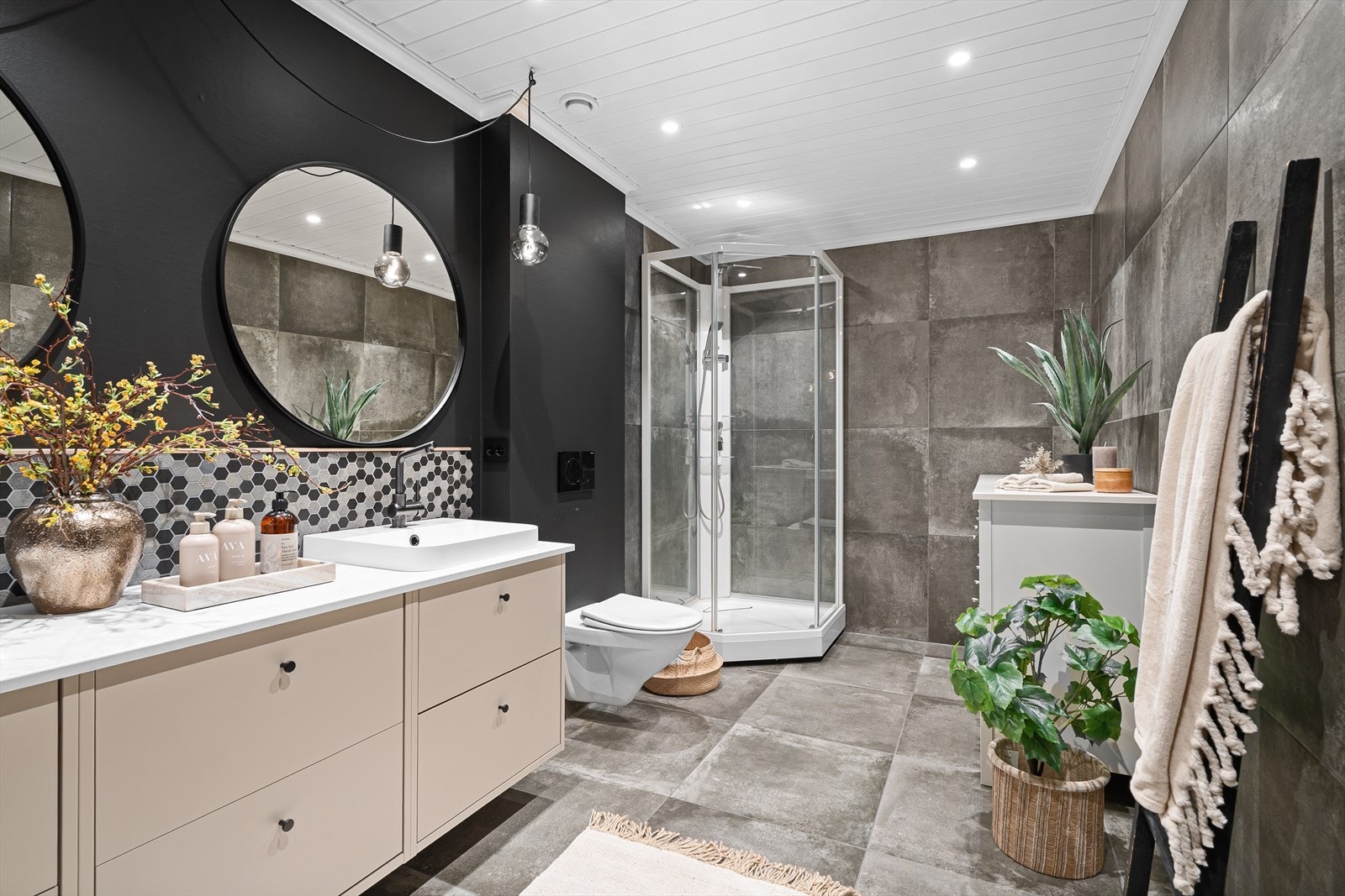 Badet er lekkert oppusset med fliser på gulvet og på deler av veggene. Det ble pusset opp i 2019, med nye fliser, overflater, vegghengt toalett, og dusjkabinett. Galleribilde