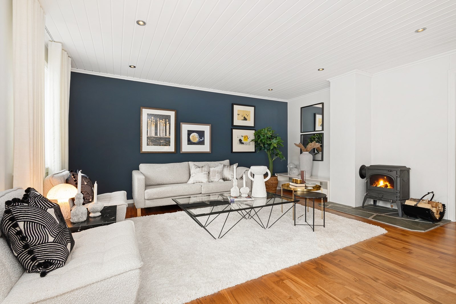 I stuen er det plass til en større sofagruppe ved vedovnen som gir godt med varme på kaldere dager. Det er parkett på gulvet og downlights i tak. Galleribilde