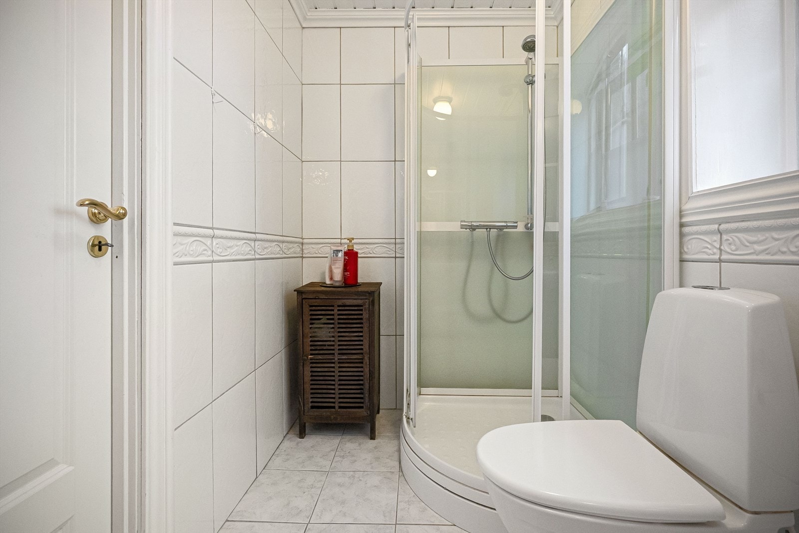 Fullfliset bad med dusjkabinett, toalett og servant. Varmekabler. Galleribilde