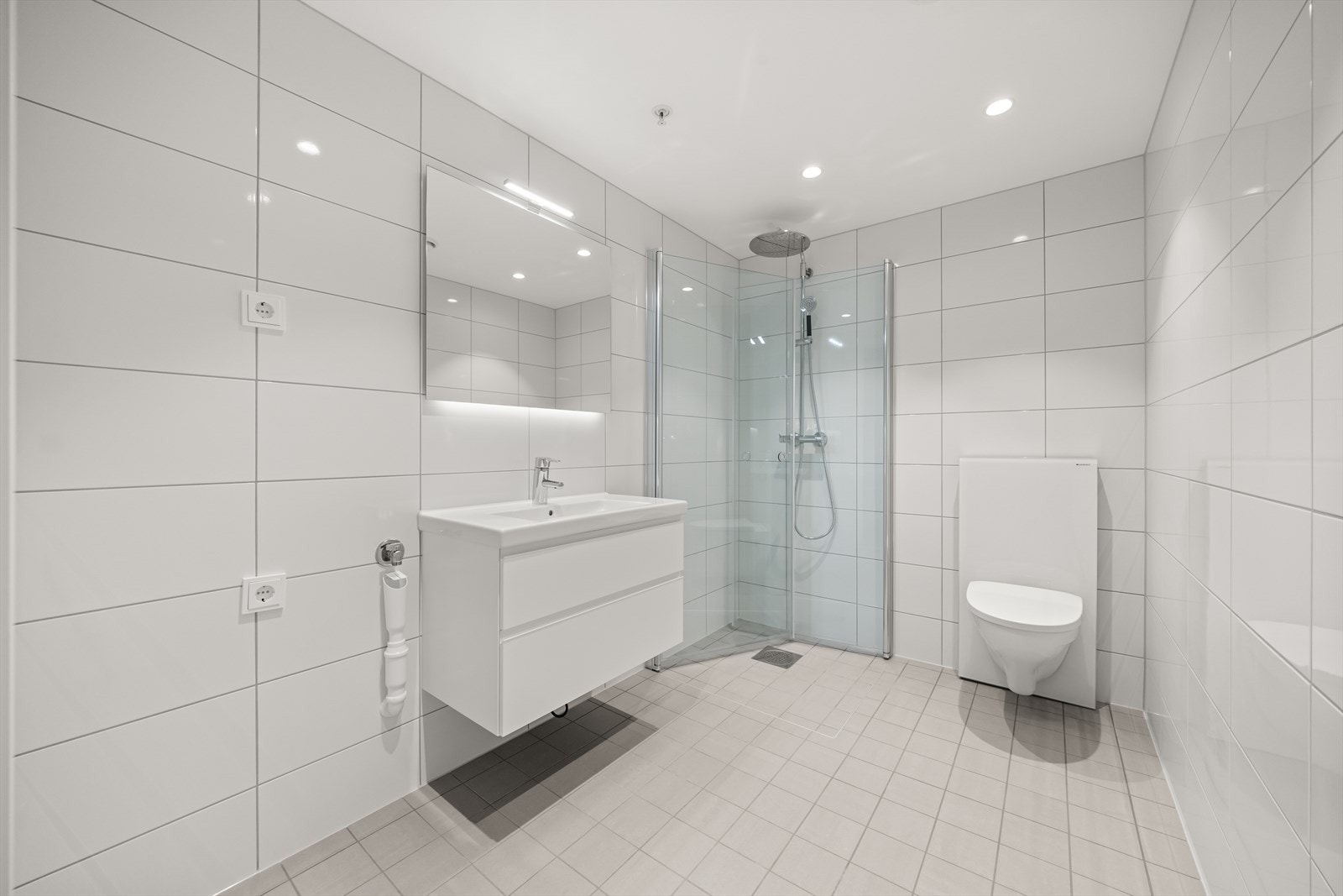 Badet ligger strategisk plassert ved entréen og er delikat flislagt med gulvvarme. Galleribilde