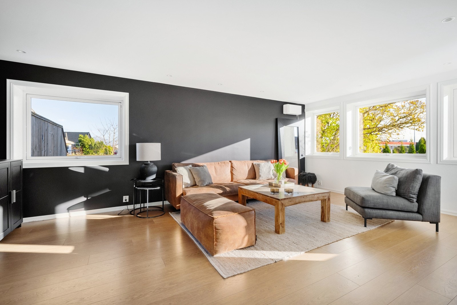 Vinduer i tre himmelretninger sørger for godt med naturlig lys, og dagslyset suppleres fint av downlights i stuen. Galleribilde
